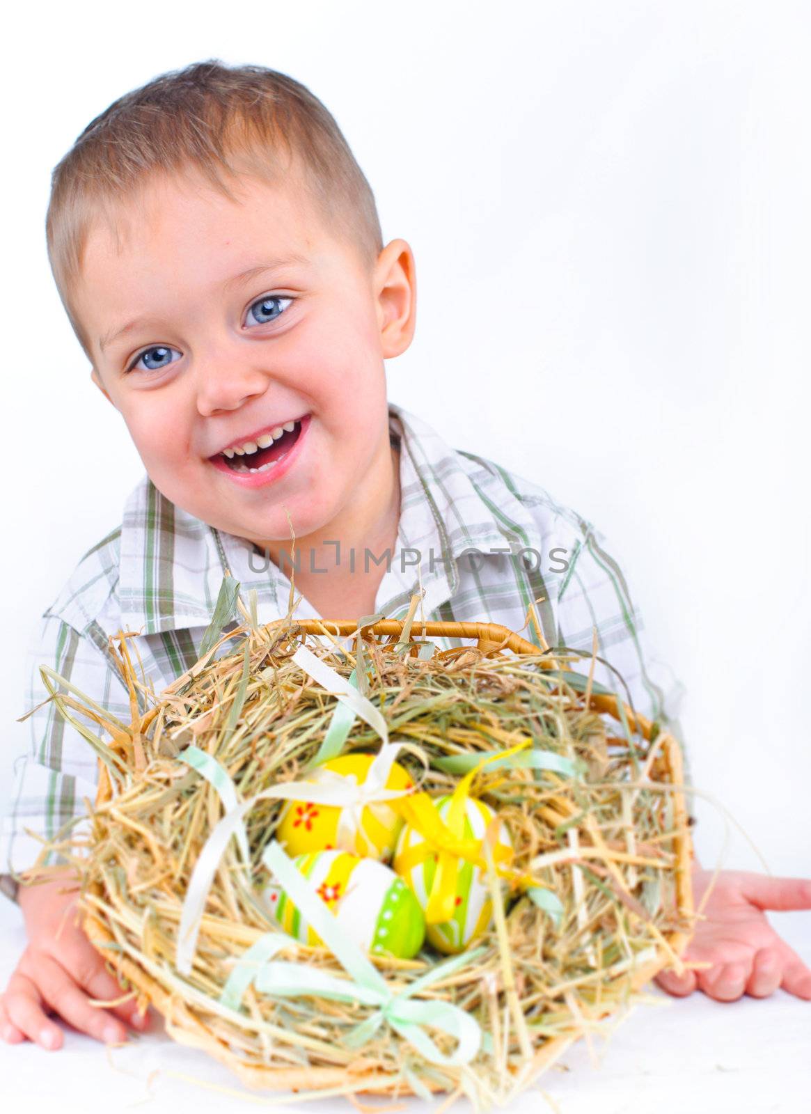 Little boy playing with easter eggs in basket