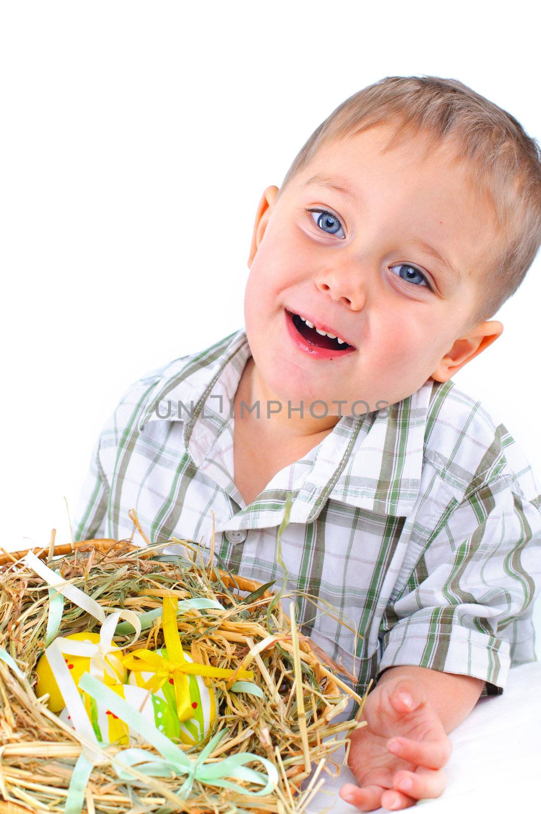 Little boy playing with easter eggs in basket
