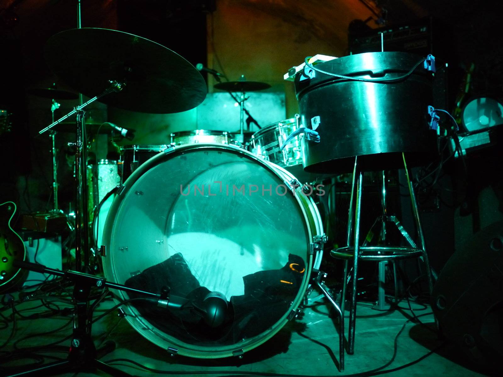 a drum set on stage in show lighting