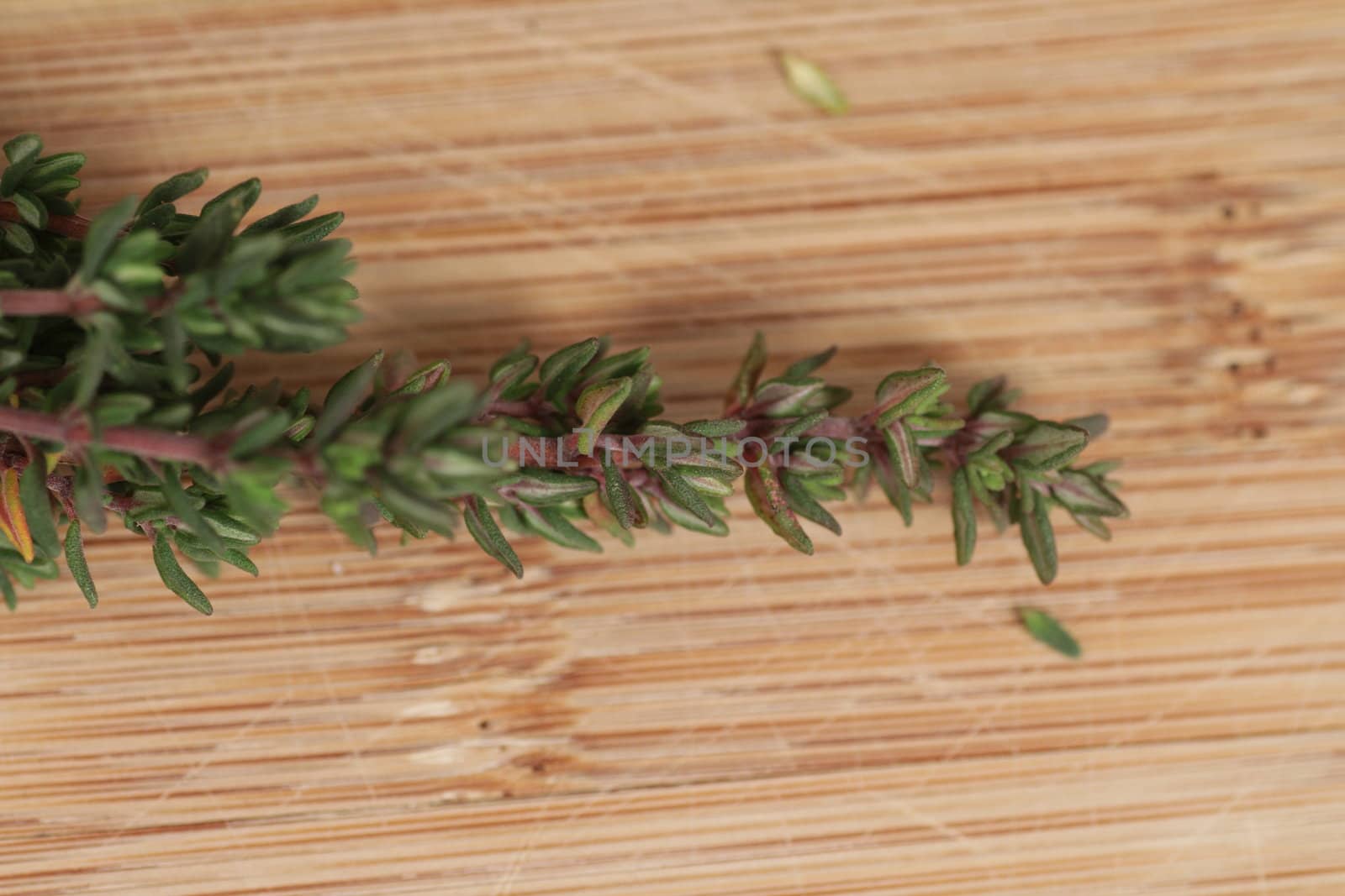 A bouquet of rosemary herbs on a weathered old chopping board.