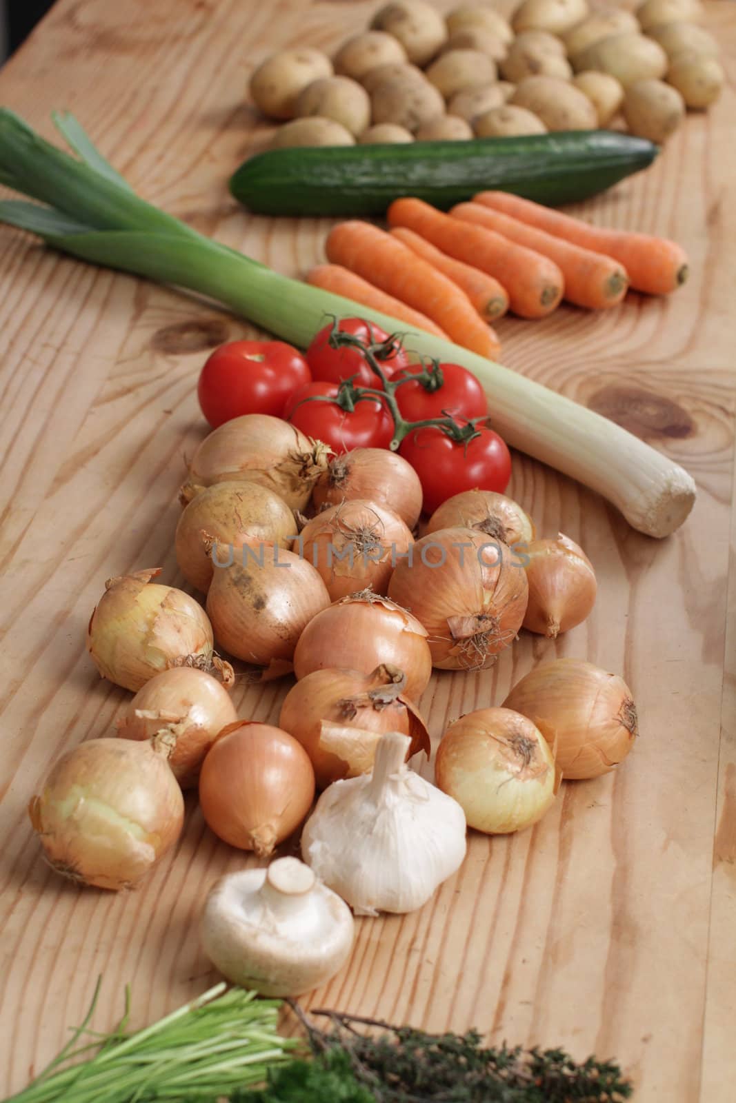 many different vegetables on a wooden table