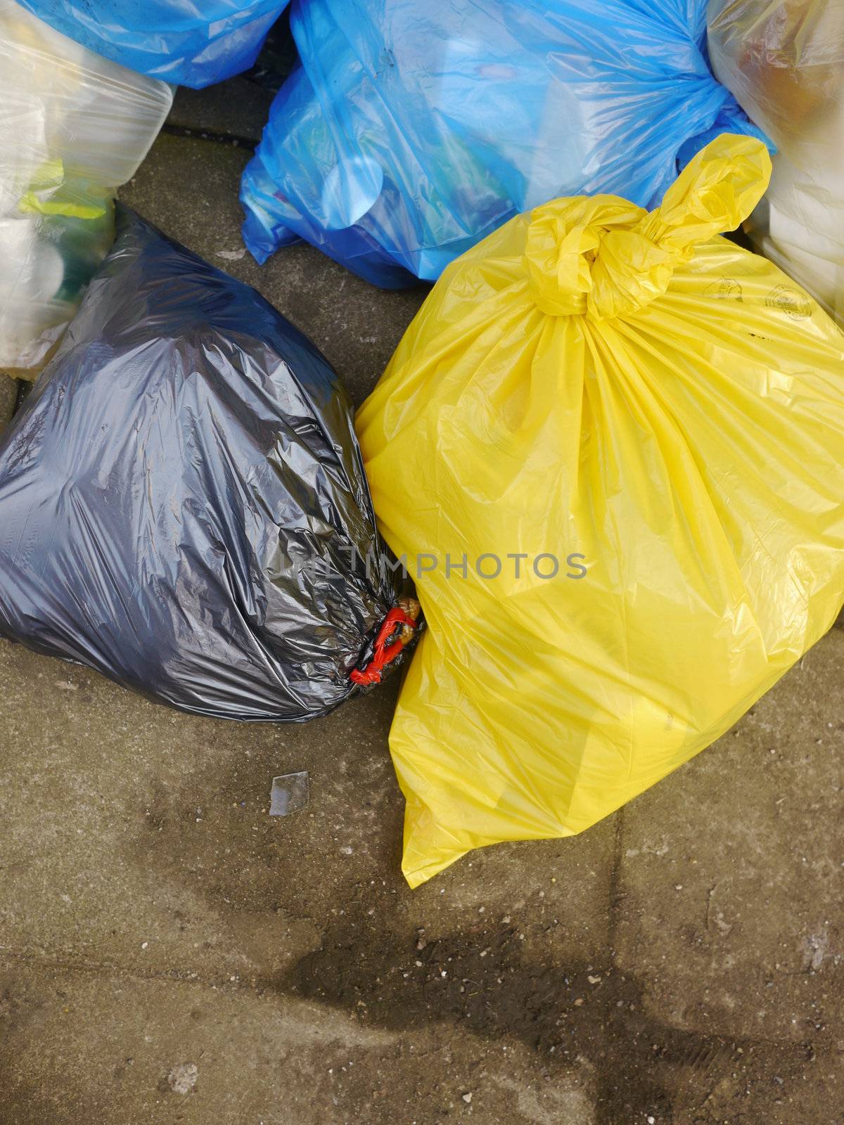 Many Garbage Plastic Bags With Different Colours Piled Up