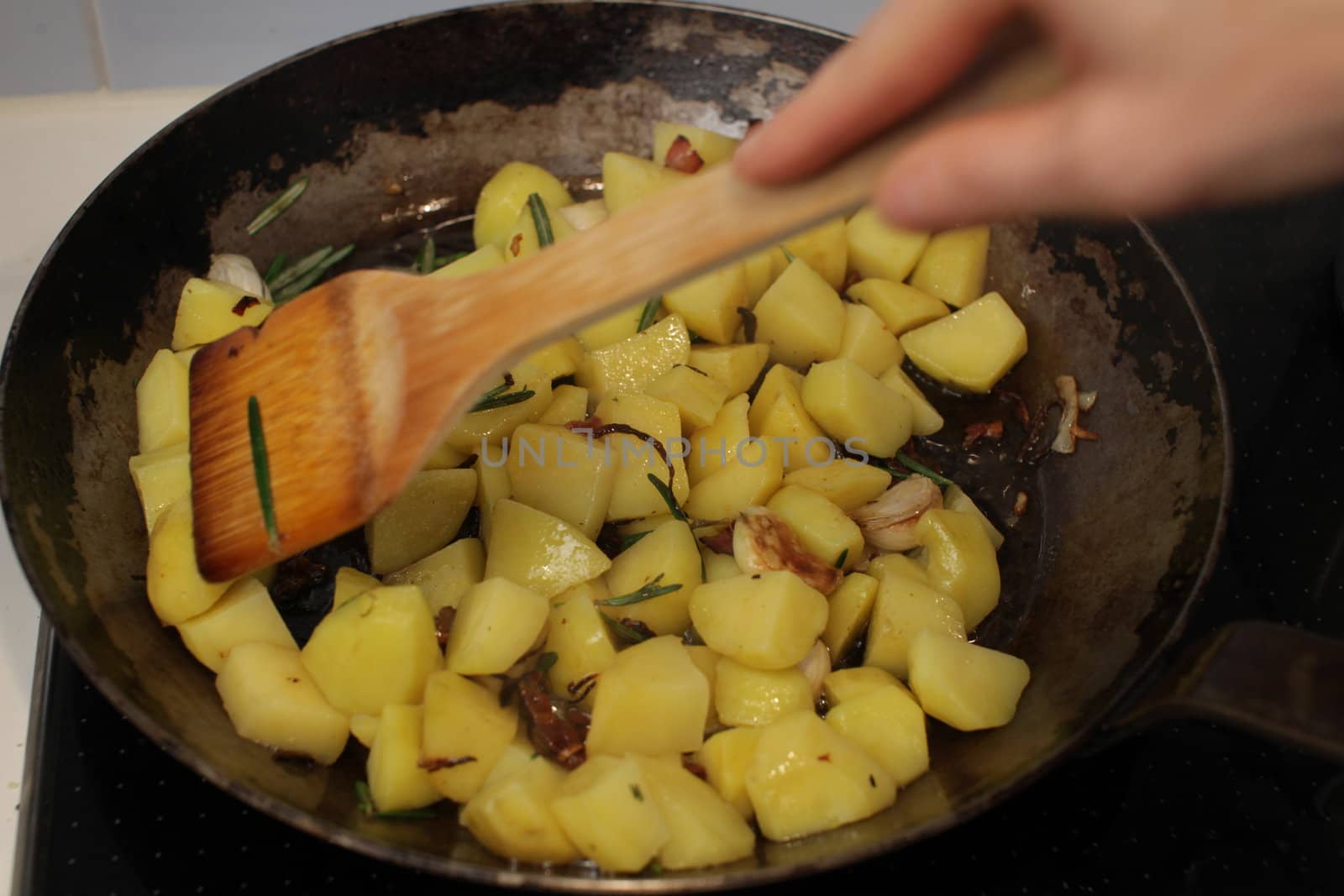 Close-up of sauteed potatoes in a griddle pan