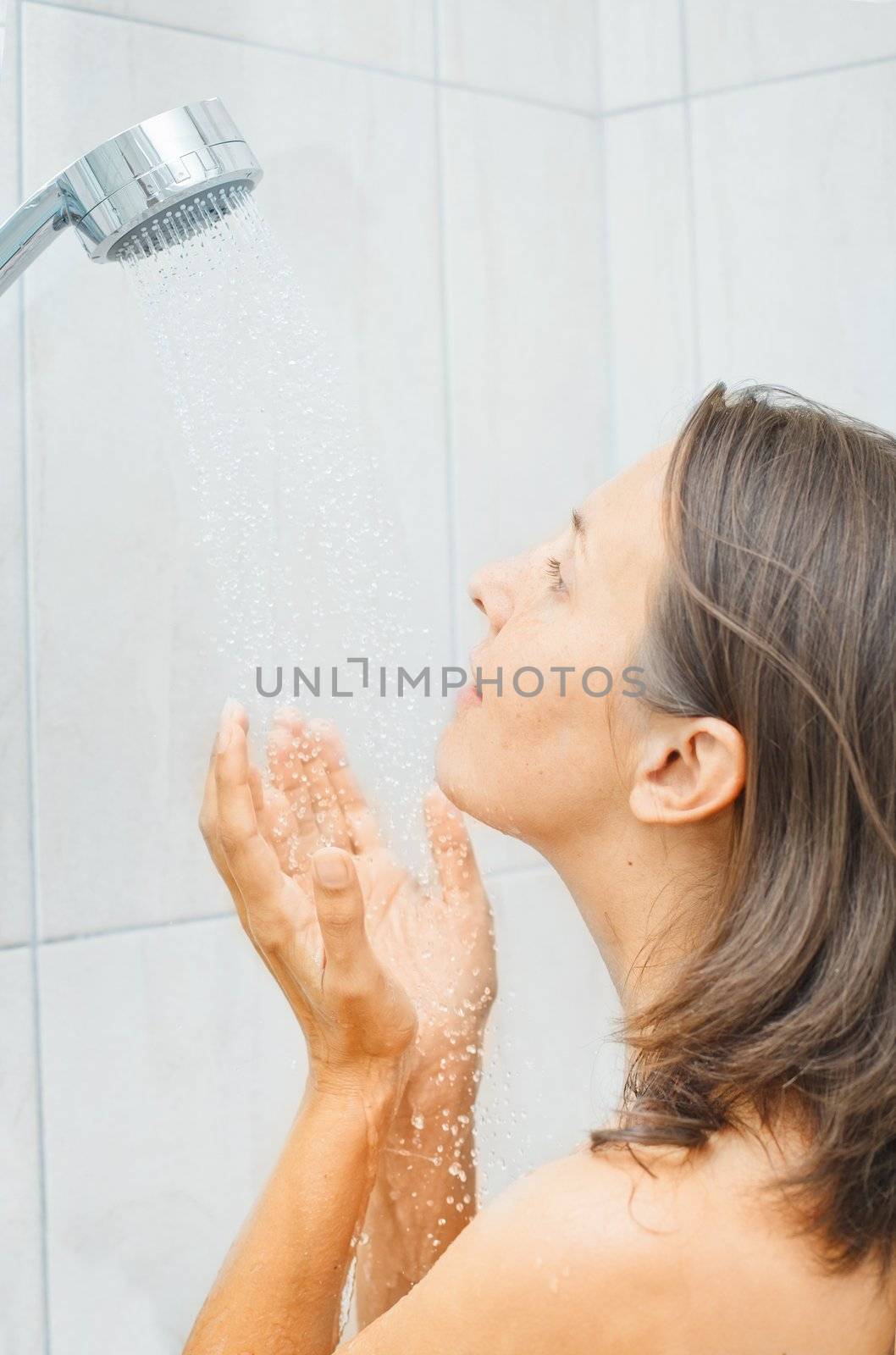 Young beautiful smile woman in shower enjoy