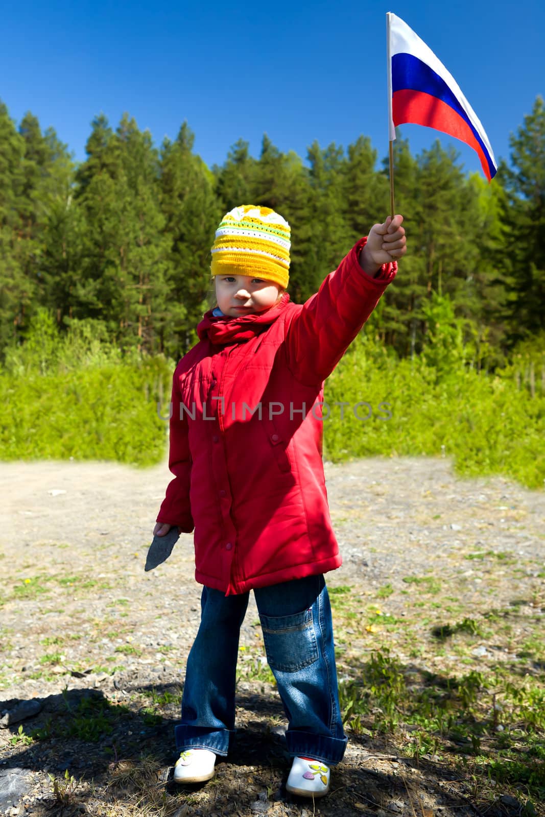 The girl with a flag of Russia against wood
