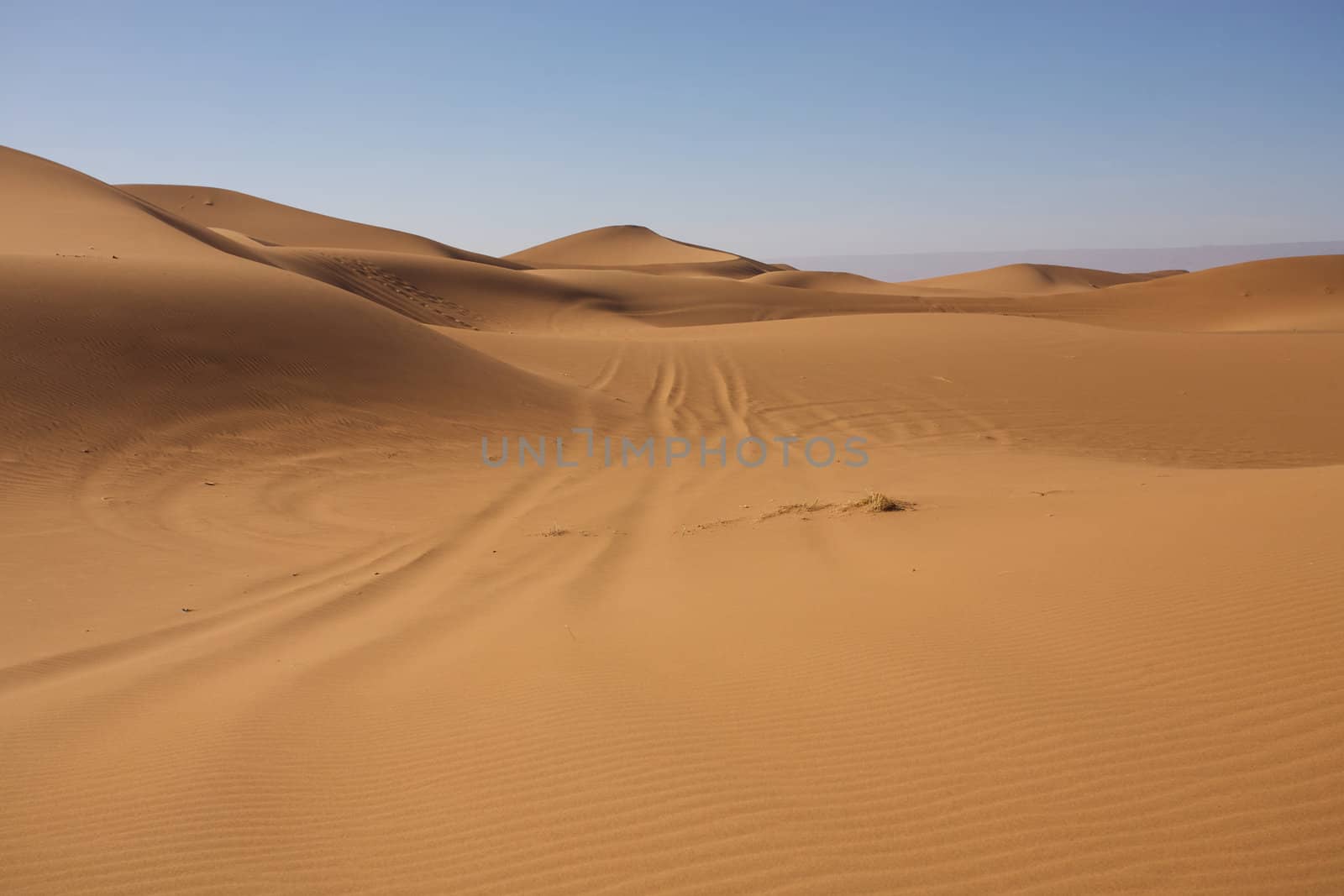 Sahara desert close to Merzouga in Morocco with blue sky and clouds