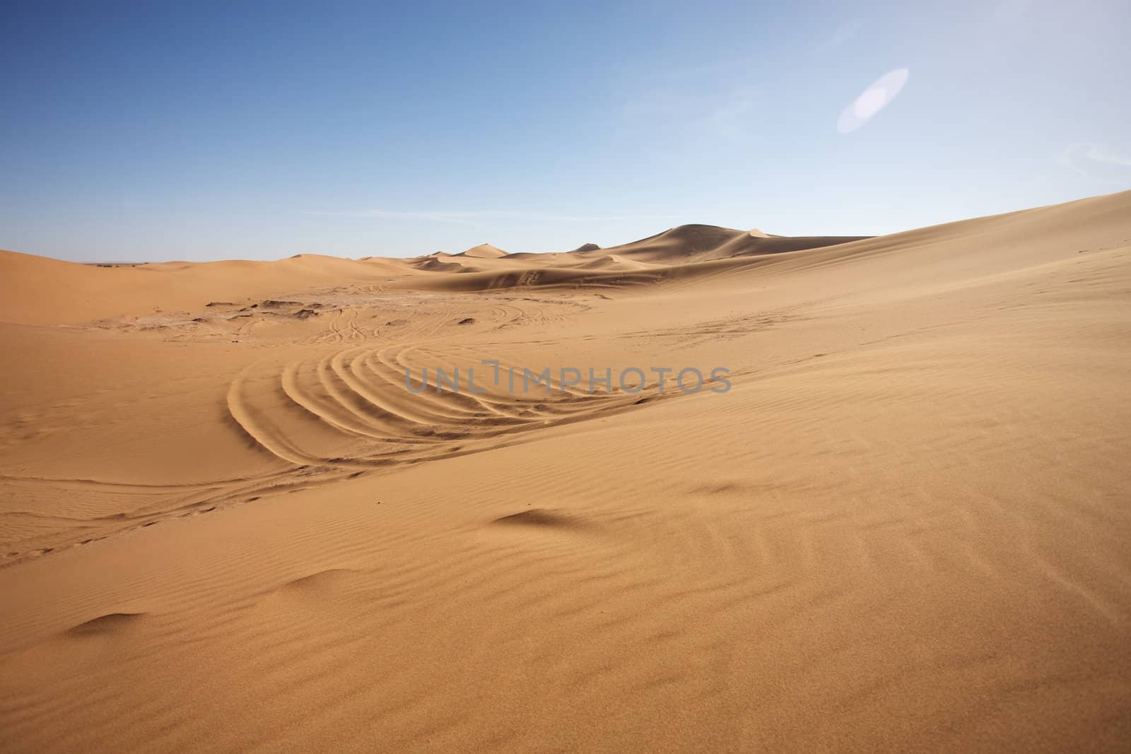 Sahara desert close to Merzouga in Morocco with blue sky and clouds