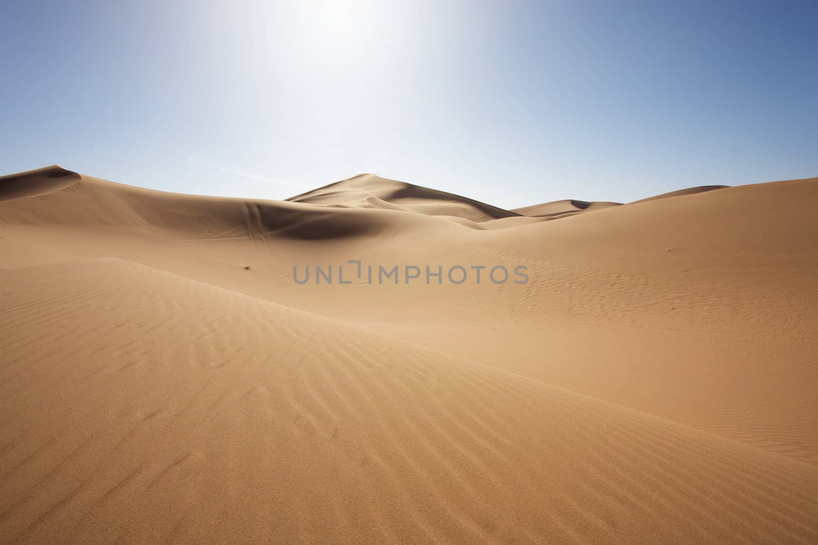 Sahara desert close to Merzouga in Morocco with blue sky and clouds