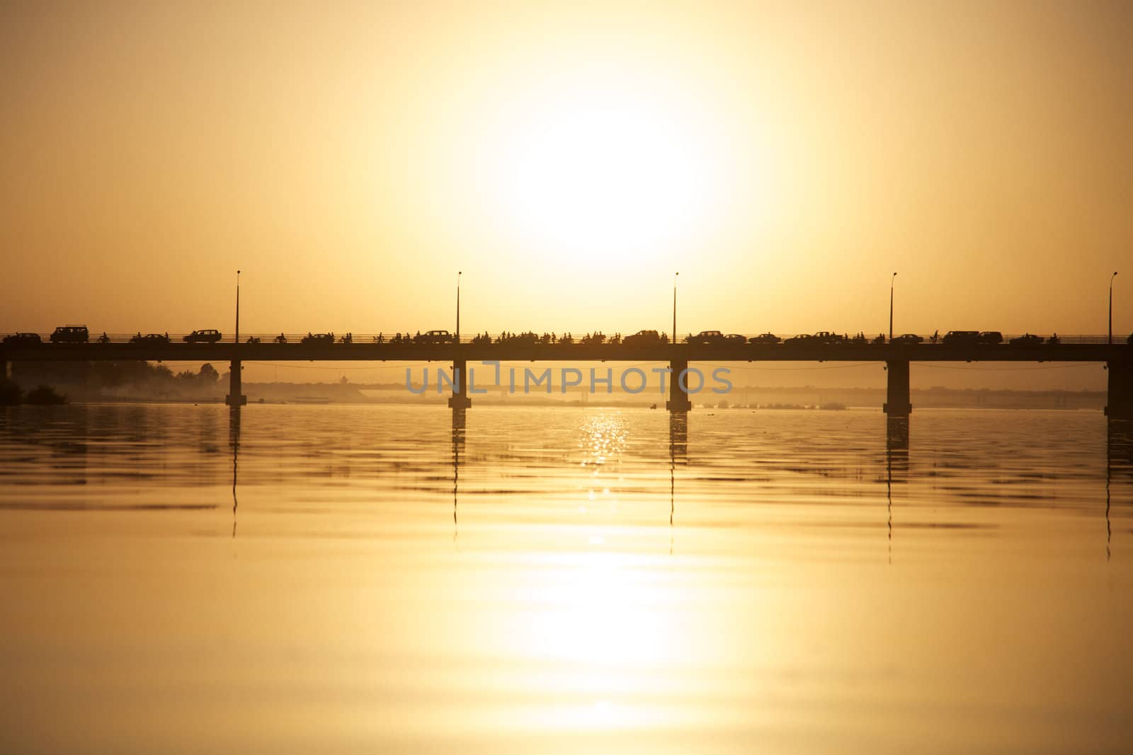 Pont des martyrs Bridge in Bamako on the river the Niger with a beautiful sunset with people, cars and motorbikes