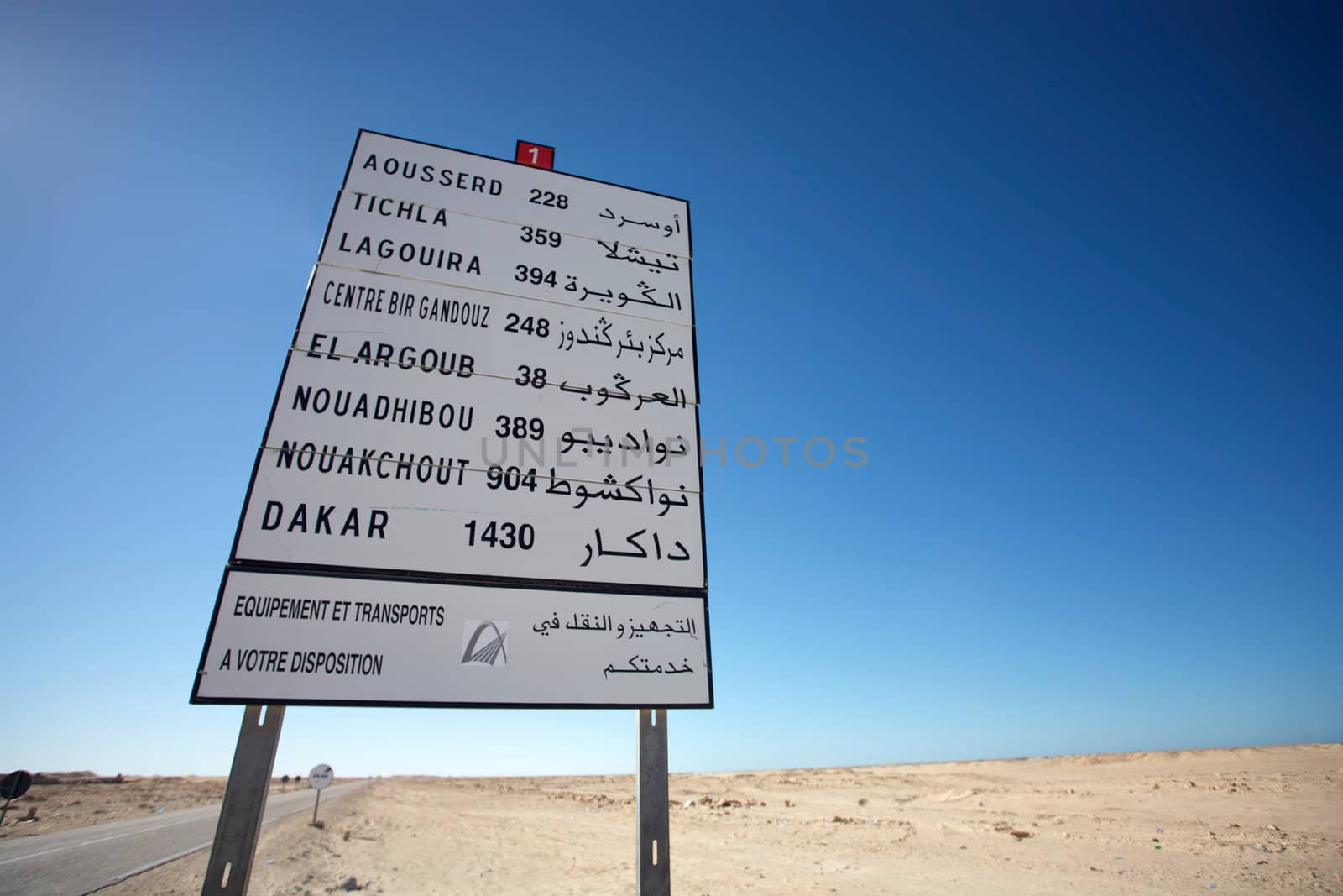 White road Sign on the road to Mauritania with blue sky