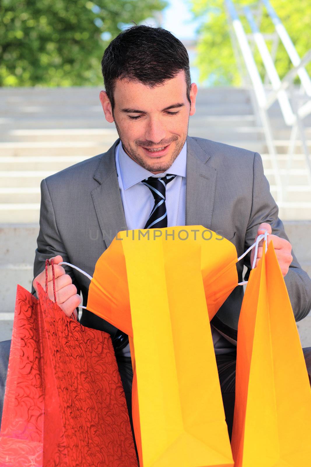 businessman looking in a bag after shopping