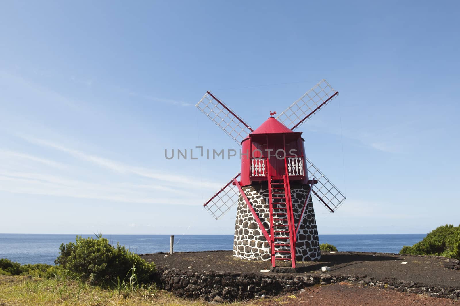 Red windmill in the coast of Pico island, Azores