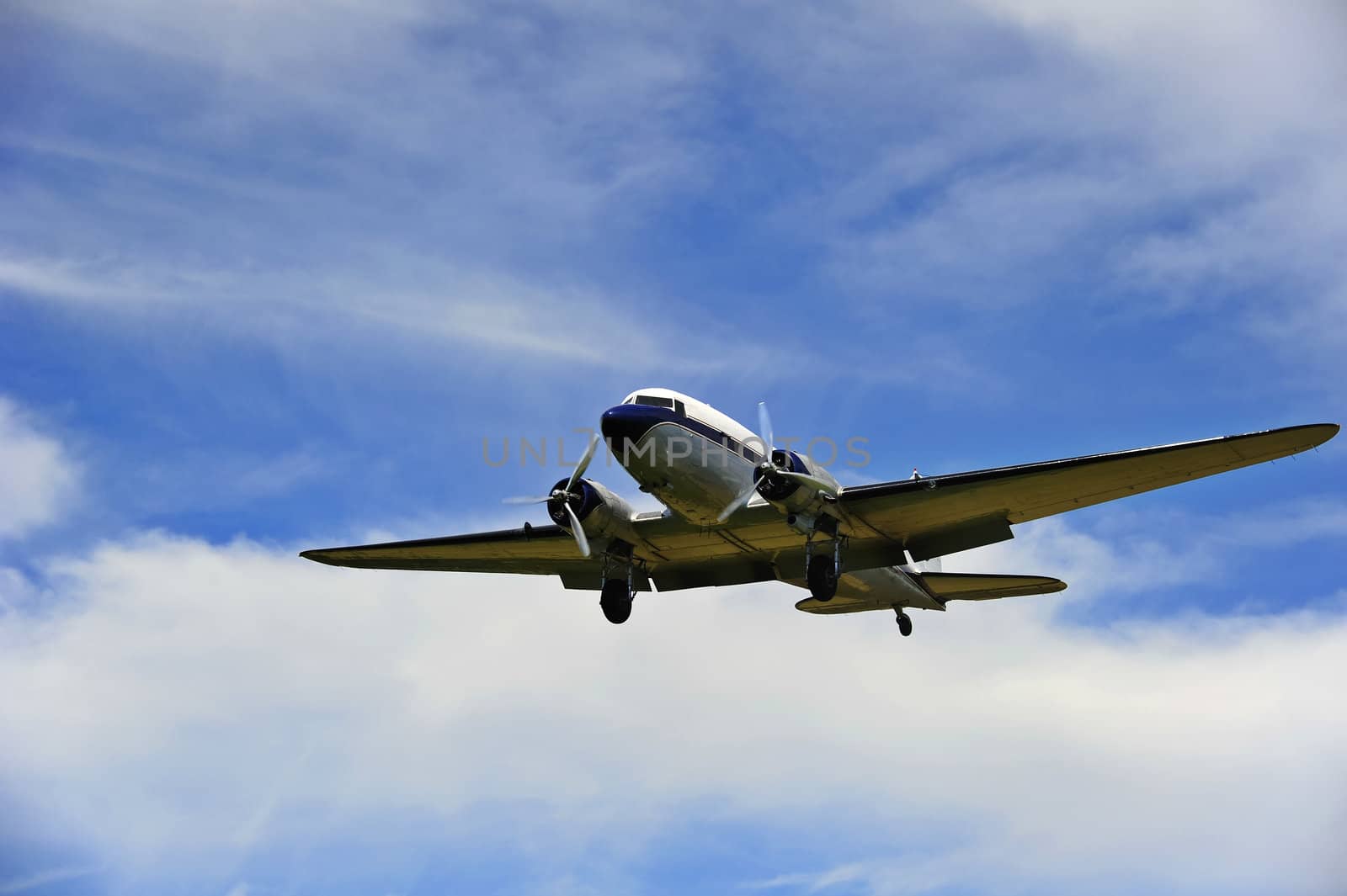 A vintage Douglas DC-3A (Dakota) coming in to land at an airfield