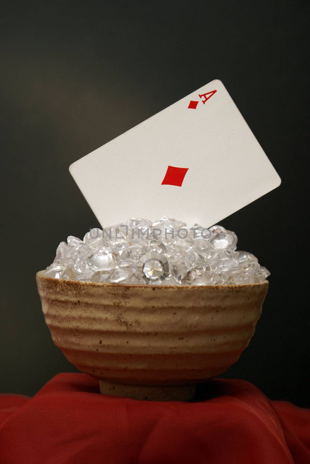 The ace of diamonds rest in a pile of white diamonds for this poker still-life.