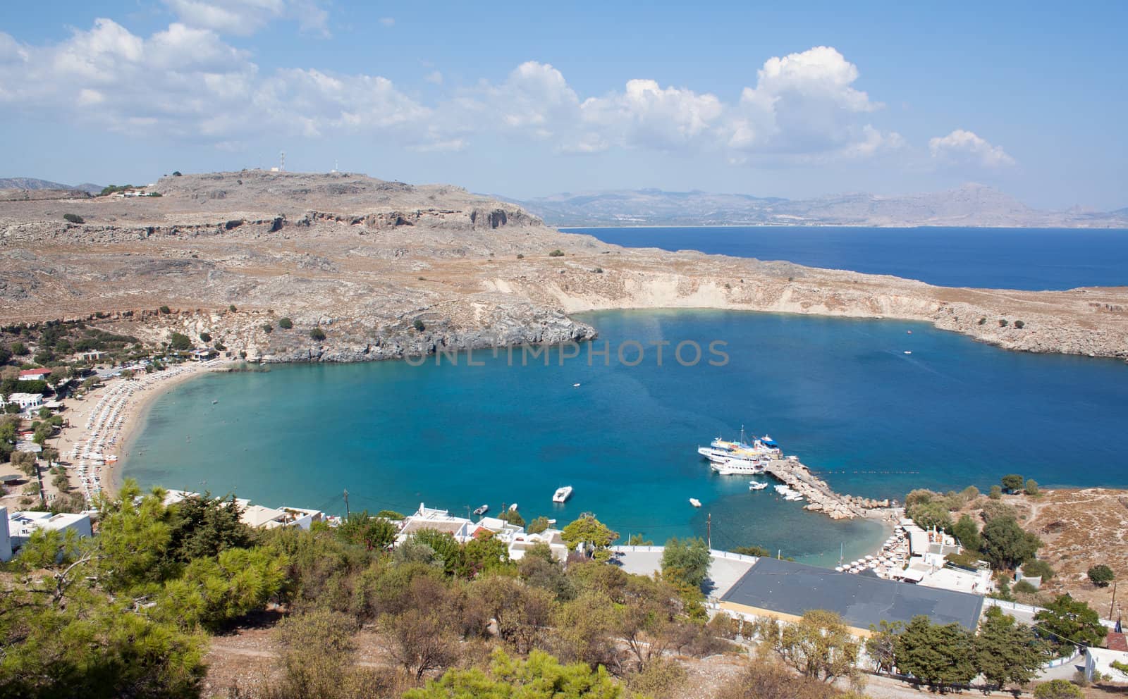 View from above of the main beach in Lindos, Rhodes, one of the Dodecanese Islands in the Aegean Sea, Greece.