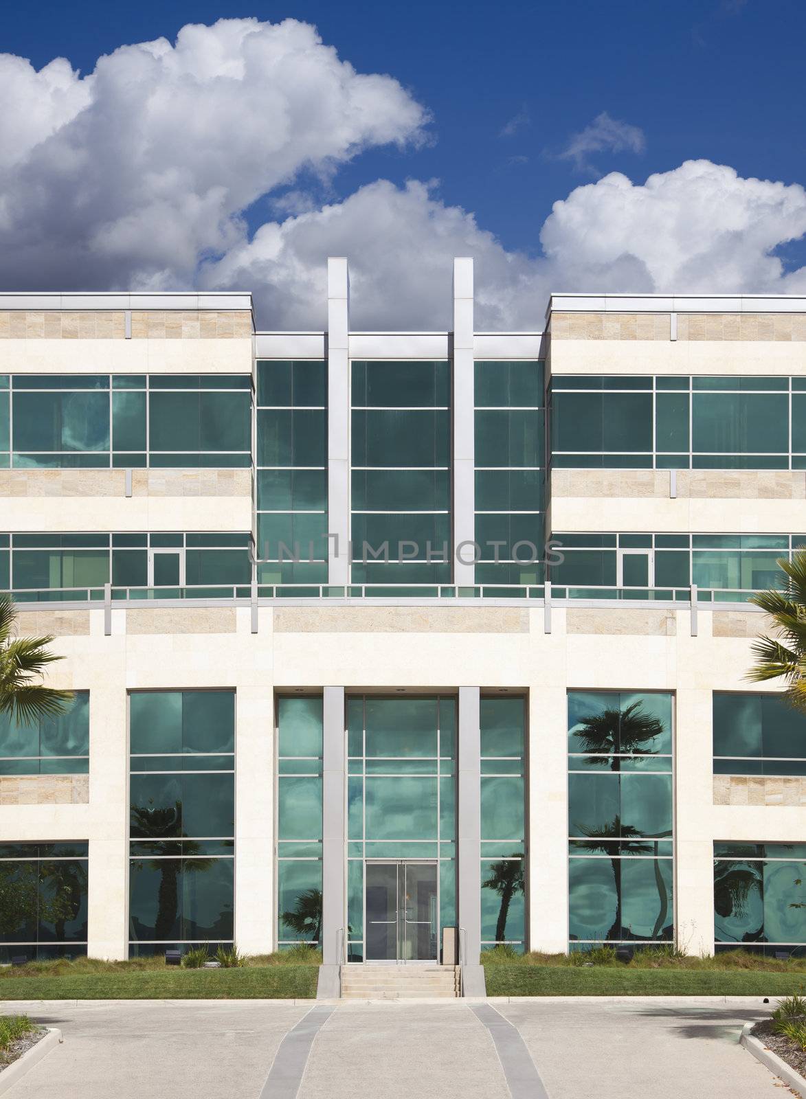 Dramatic Corporate Building with Blue Sky and Clouds.