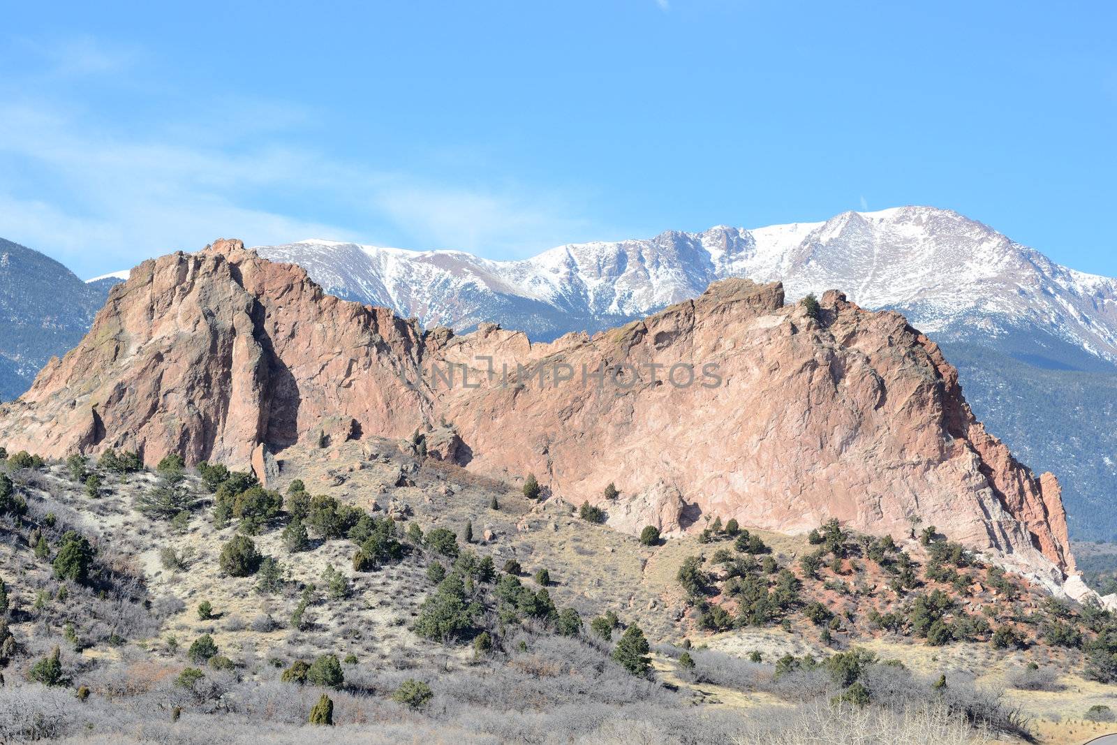Scenic view of Pikes Peak behind Gray Rock formation of Garden Of The Gods park  by Colorado Springs, Colorado.