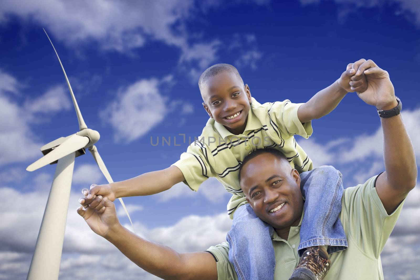 Happy African American Father and Son with Wind Turbine by Feverpitched