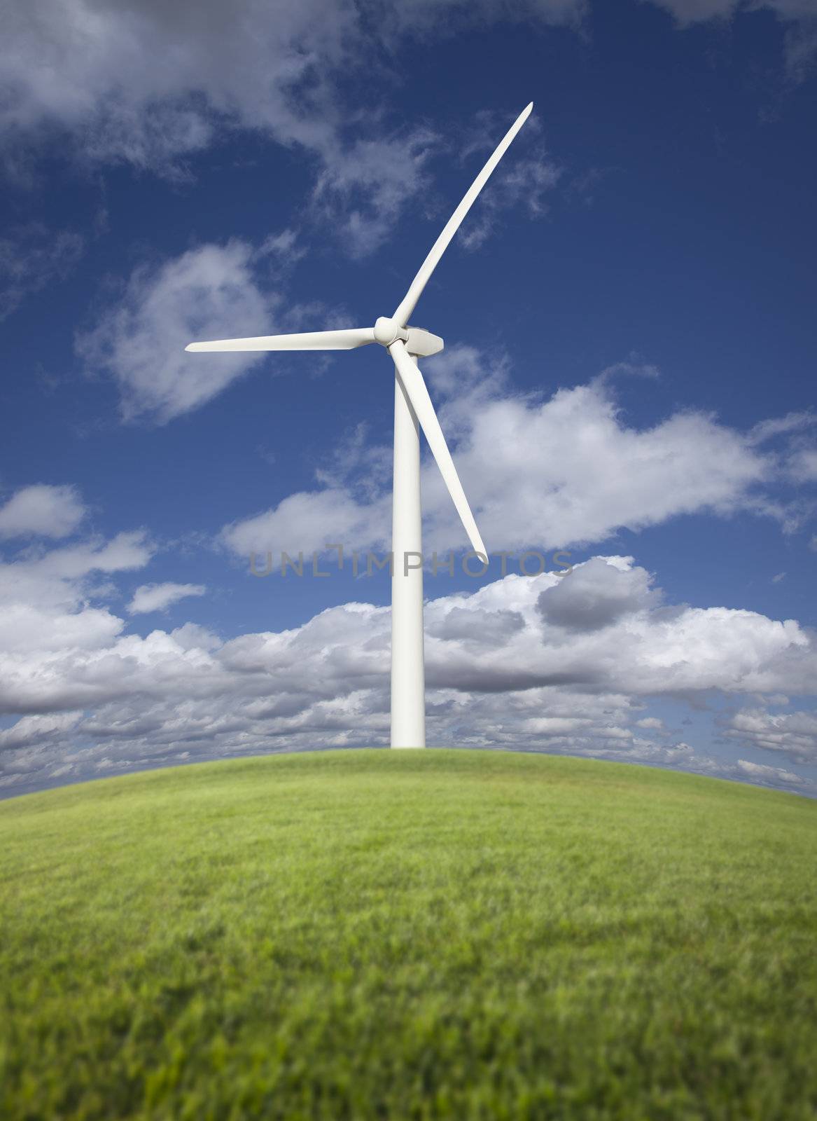 Single Wind Turbine Over Grass Field, Dramatic Sky and Clouds.