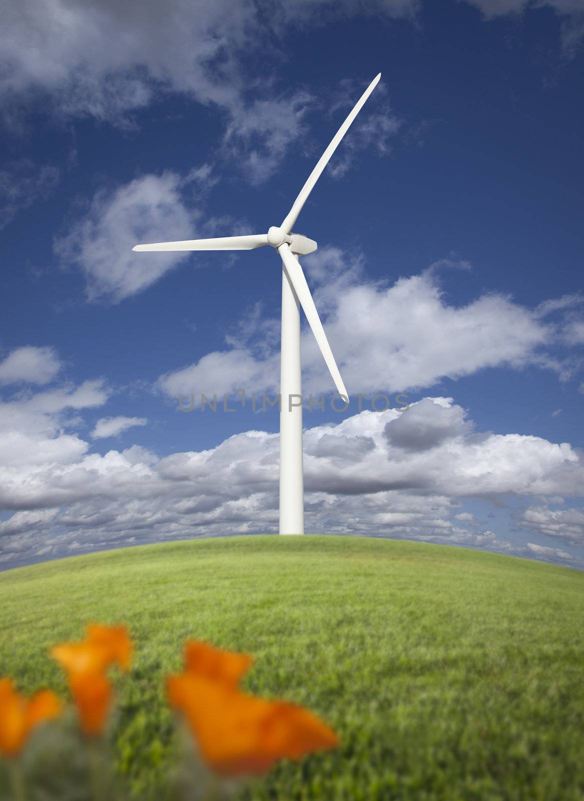 Wind Turbine Against Dramatic Sky, Clouds and California Poppies in the Foreground.
