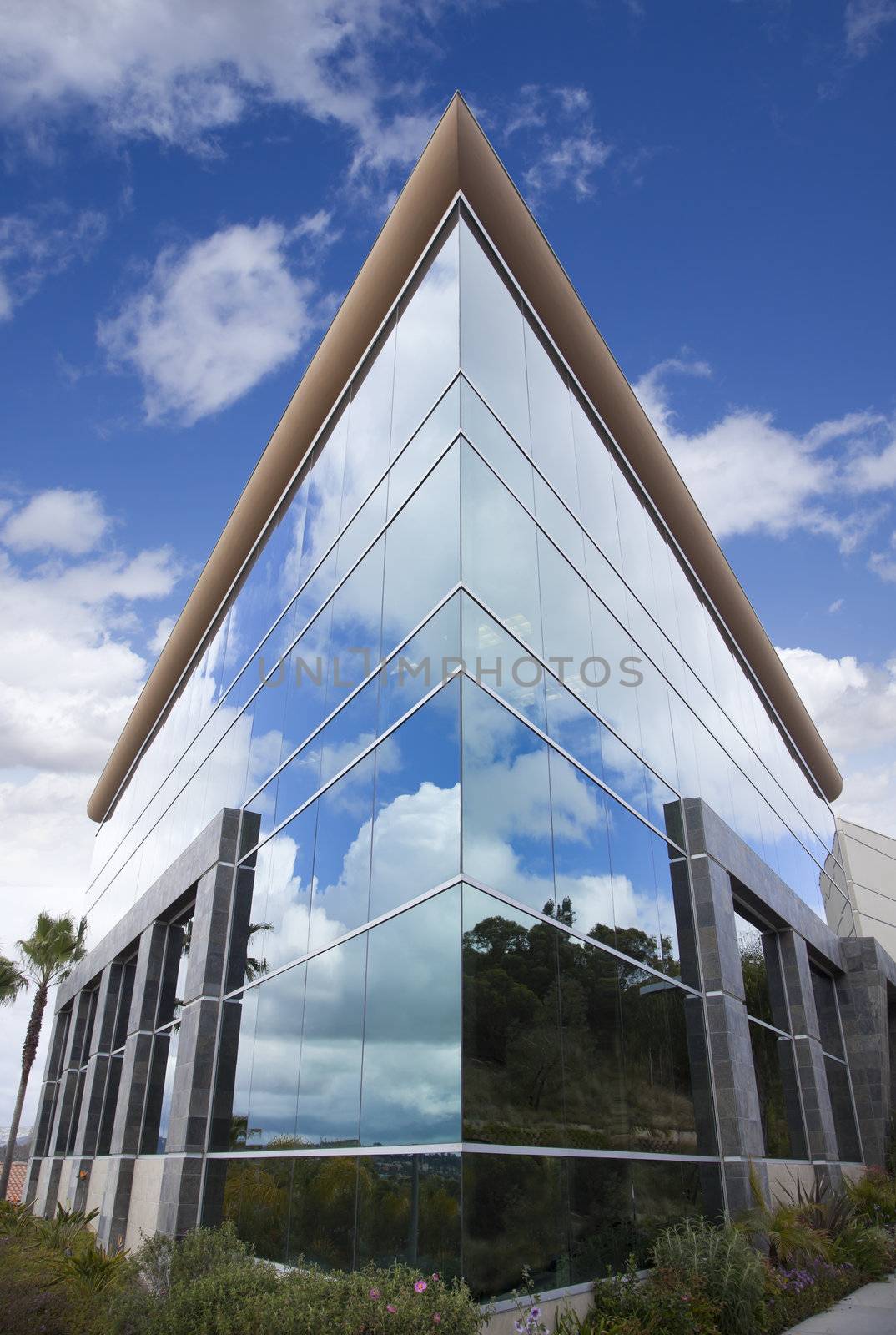 Dramatic Corporate Building with Blue Sky and Clouds.