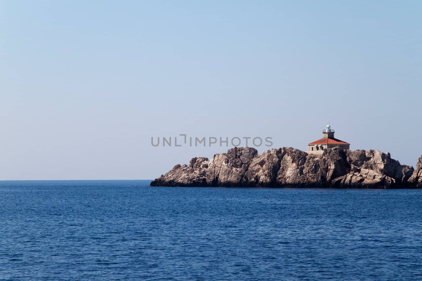 A lone lighthouse on a small island