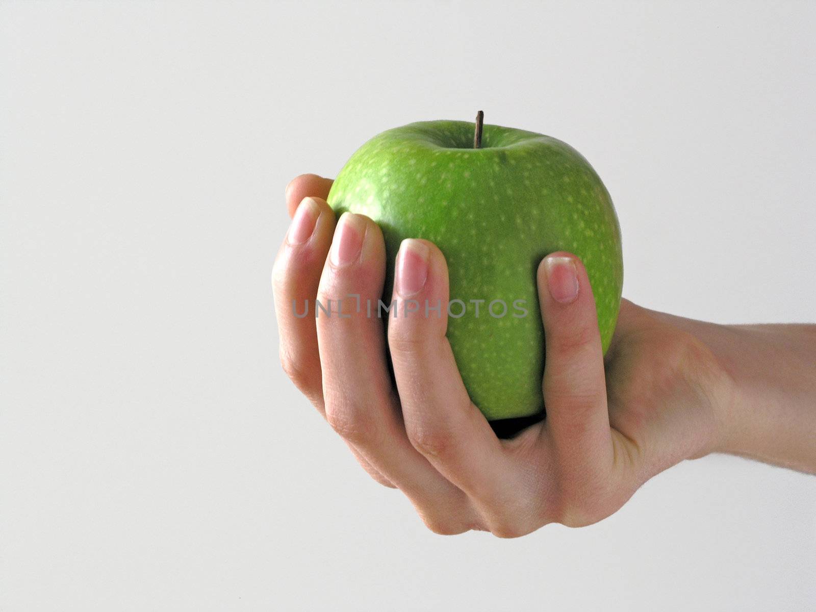 Apple in hand on white background