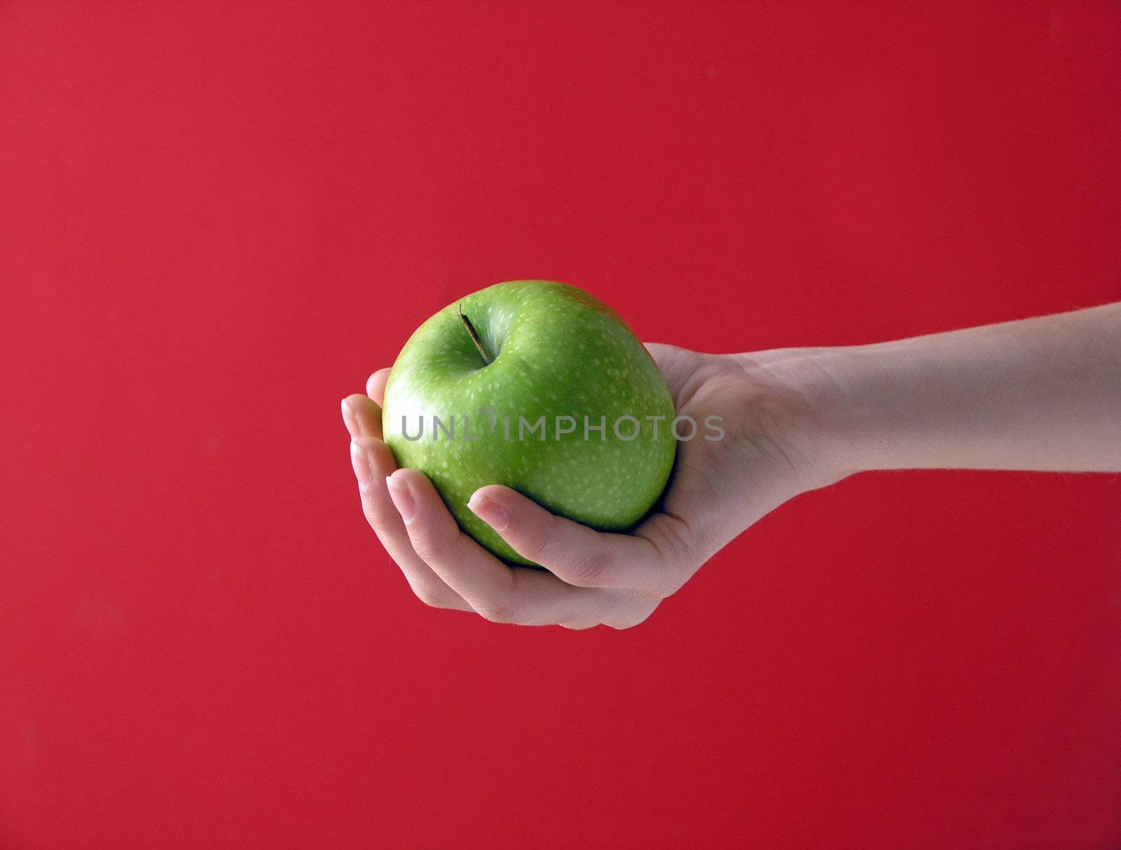 Hands with apple on red background