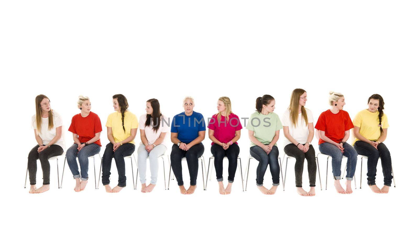 Group of Young women sitting on chairs wearing colorfull t-shirts