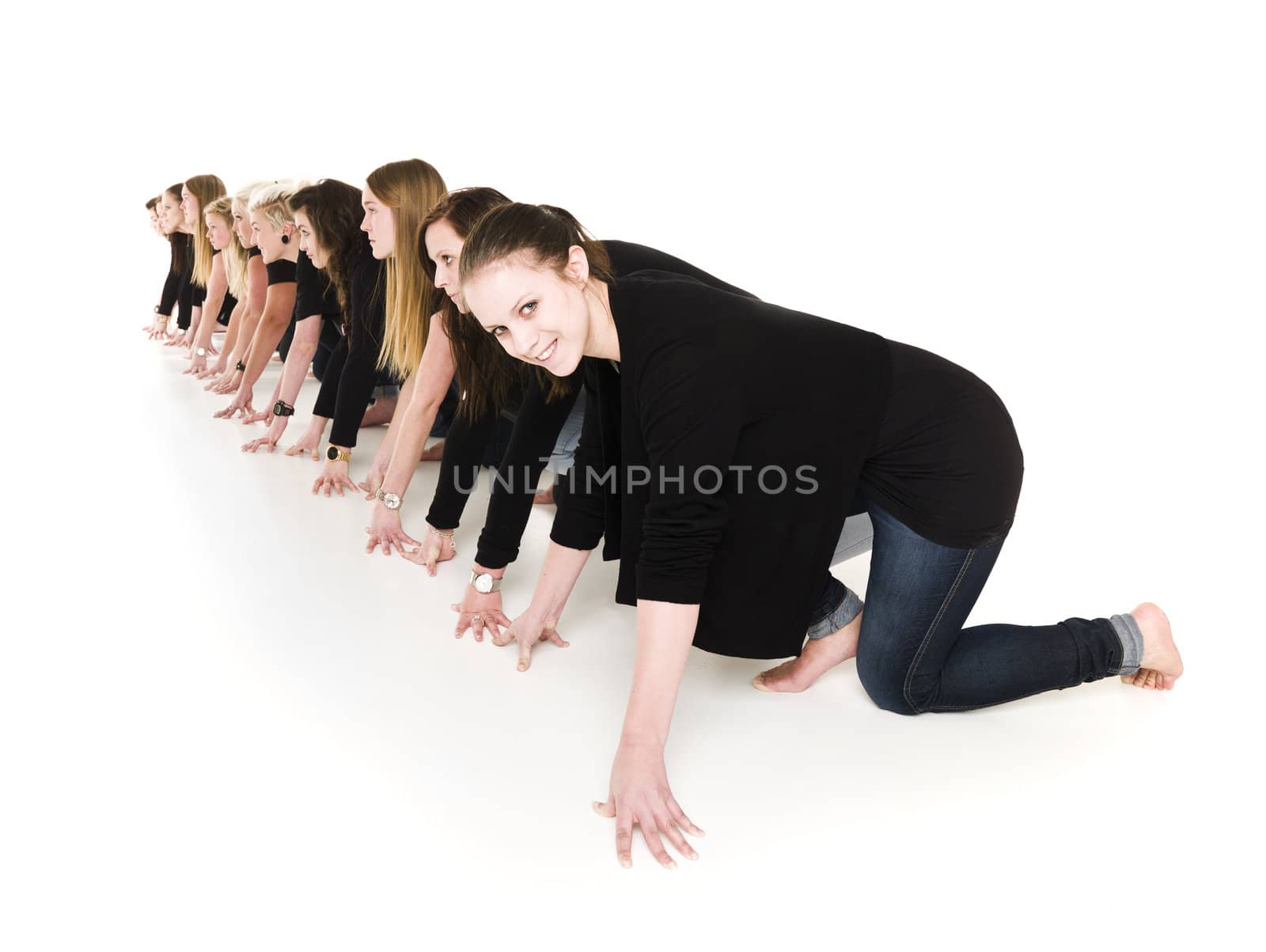 Row of young women in start position isolated on white background