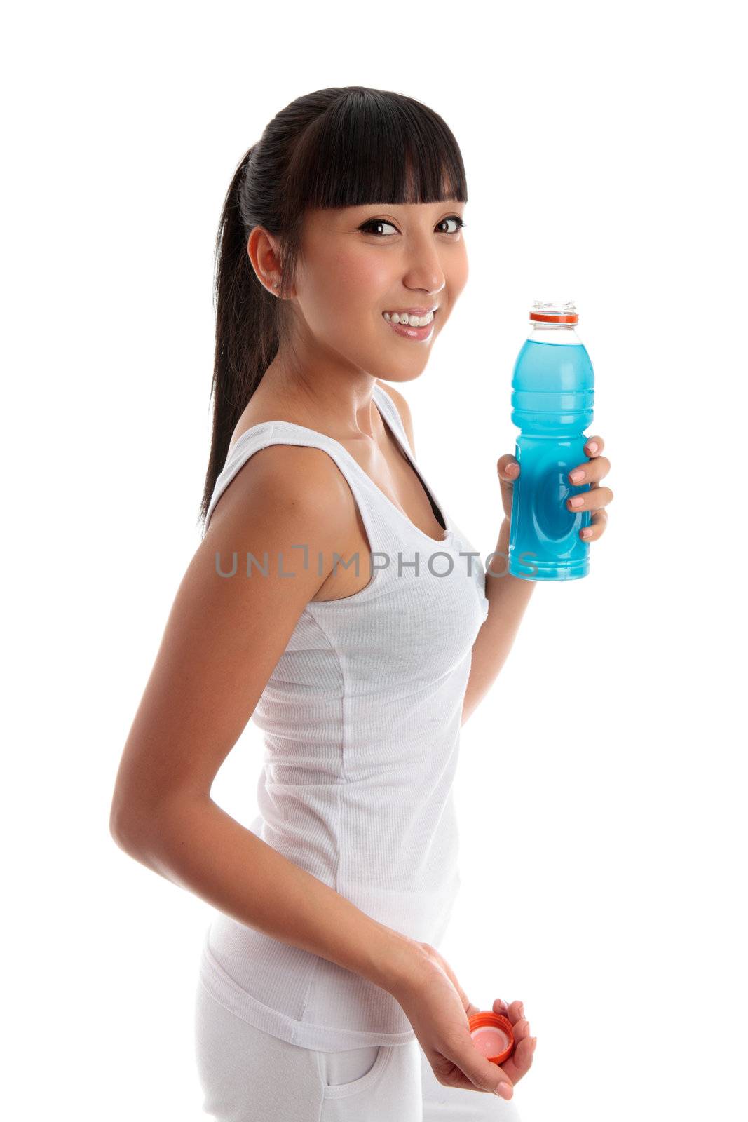 Fit healthy girl holding a bottle of drink after exercise or workout.