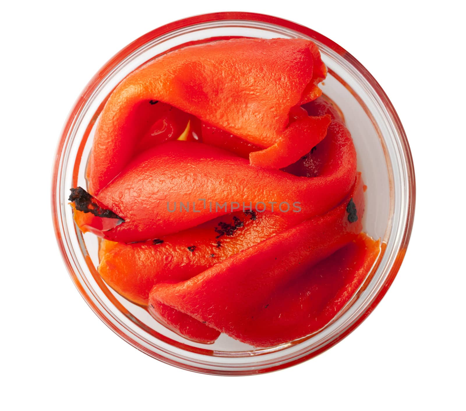 Roasted red peppers in glass bowl, shot from directly above and isolated on white.