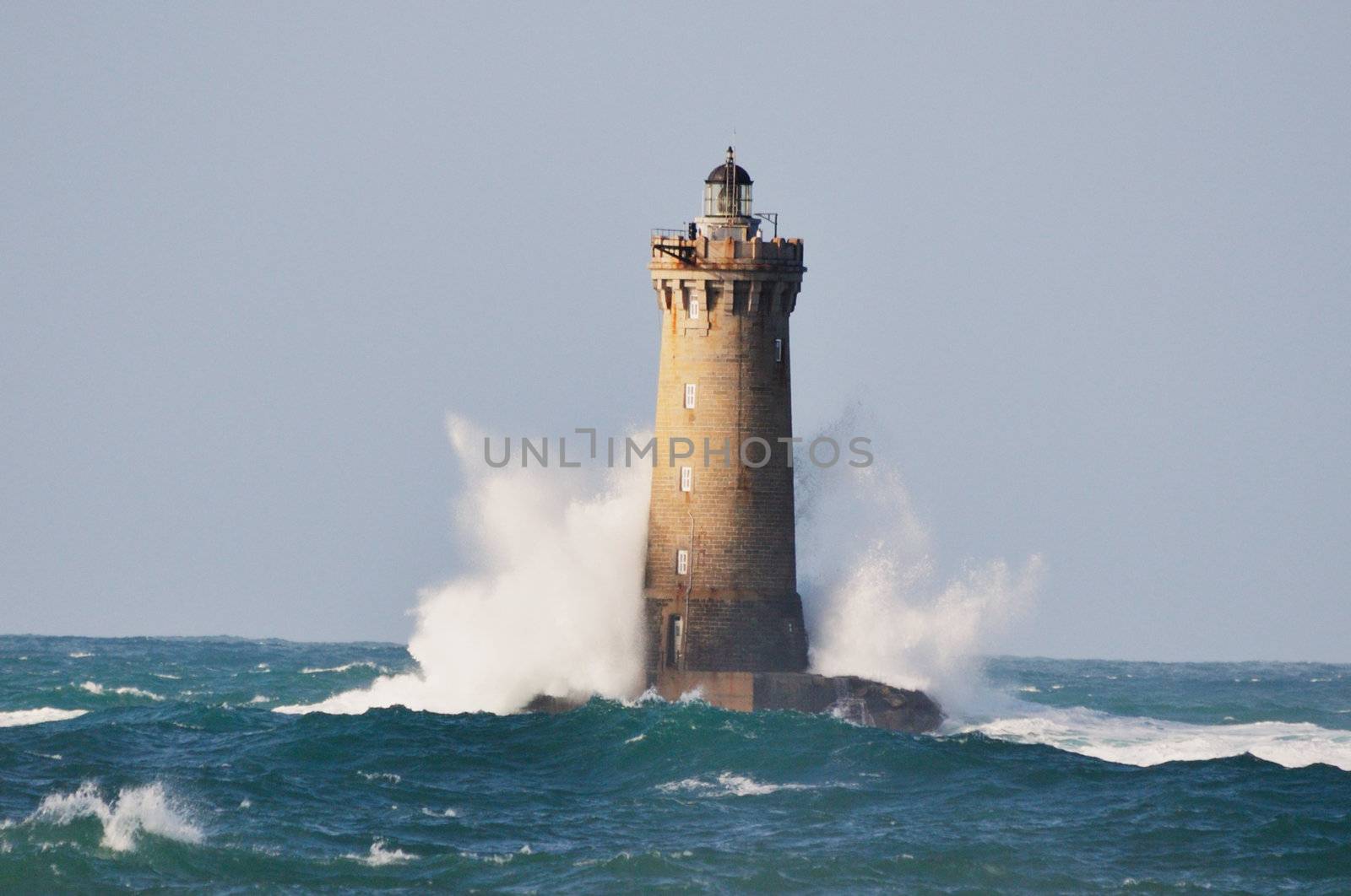 Lighthouse called "Le phare du four" in Tremazan in Brittany, France during storm in November
