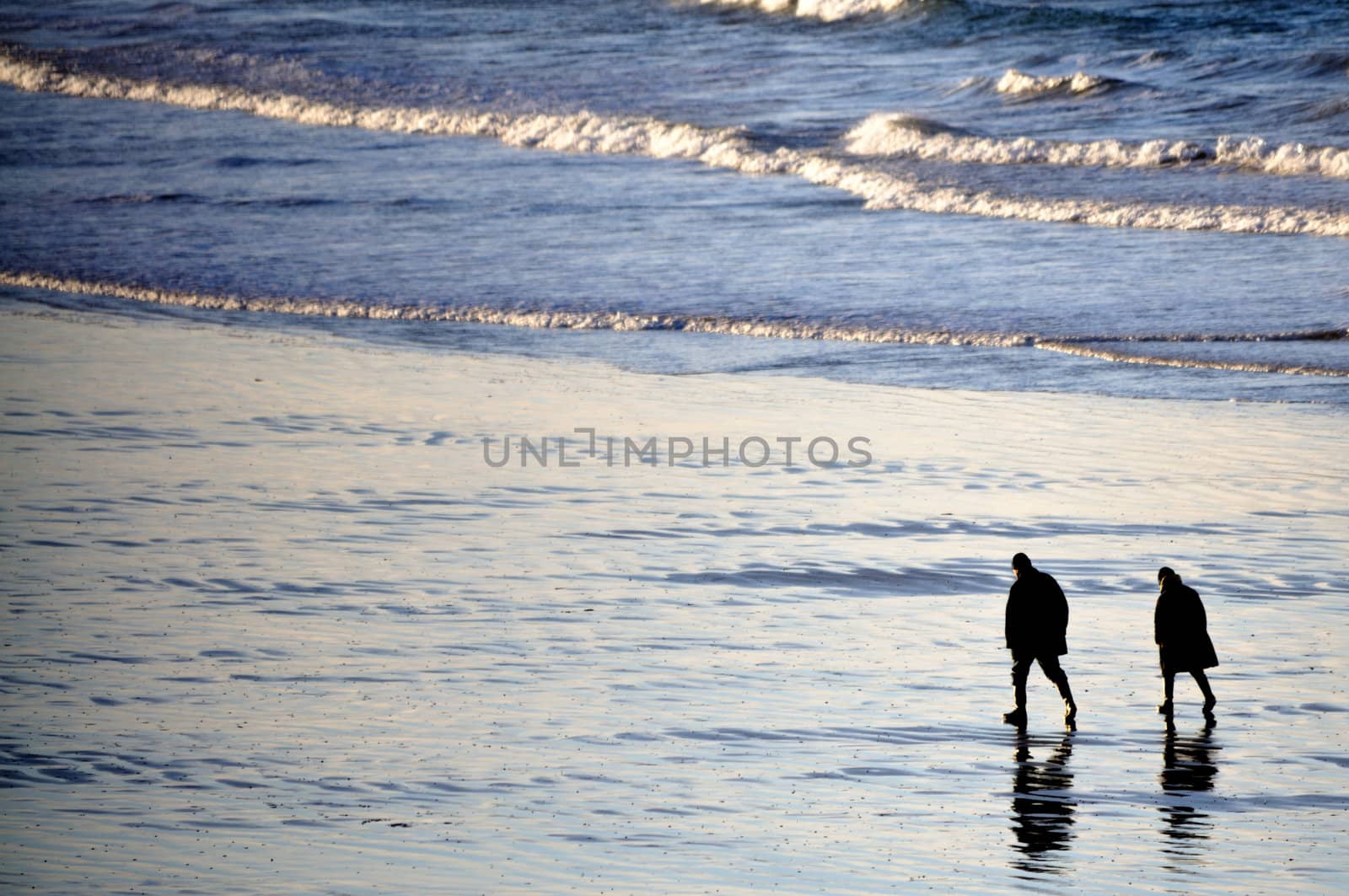 Shot of adult couple walking on the beach of Saint-Malo in brittany, france