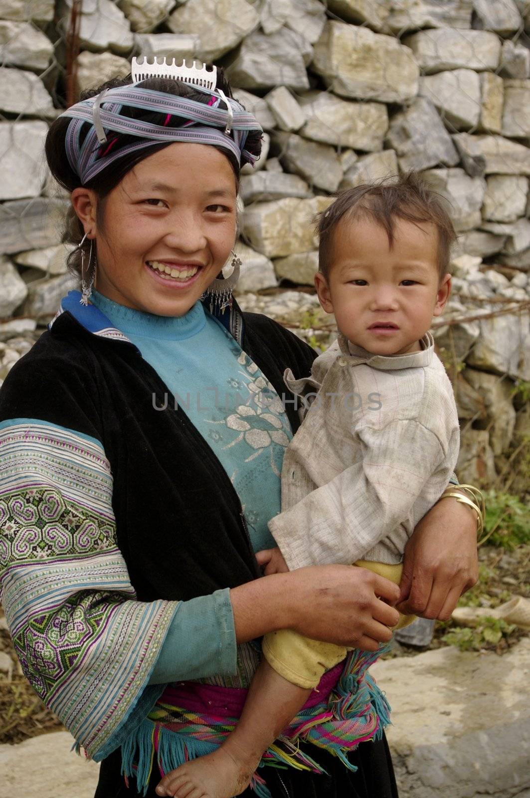 Portrait of a young blue Hmong woman and her child by Duroc