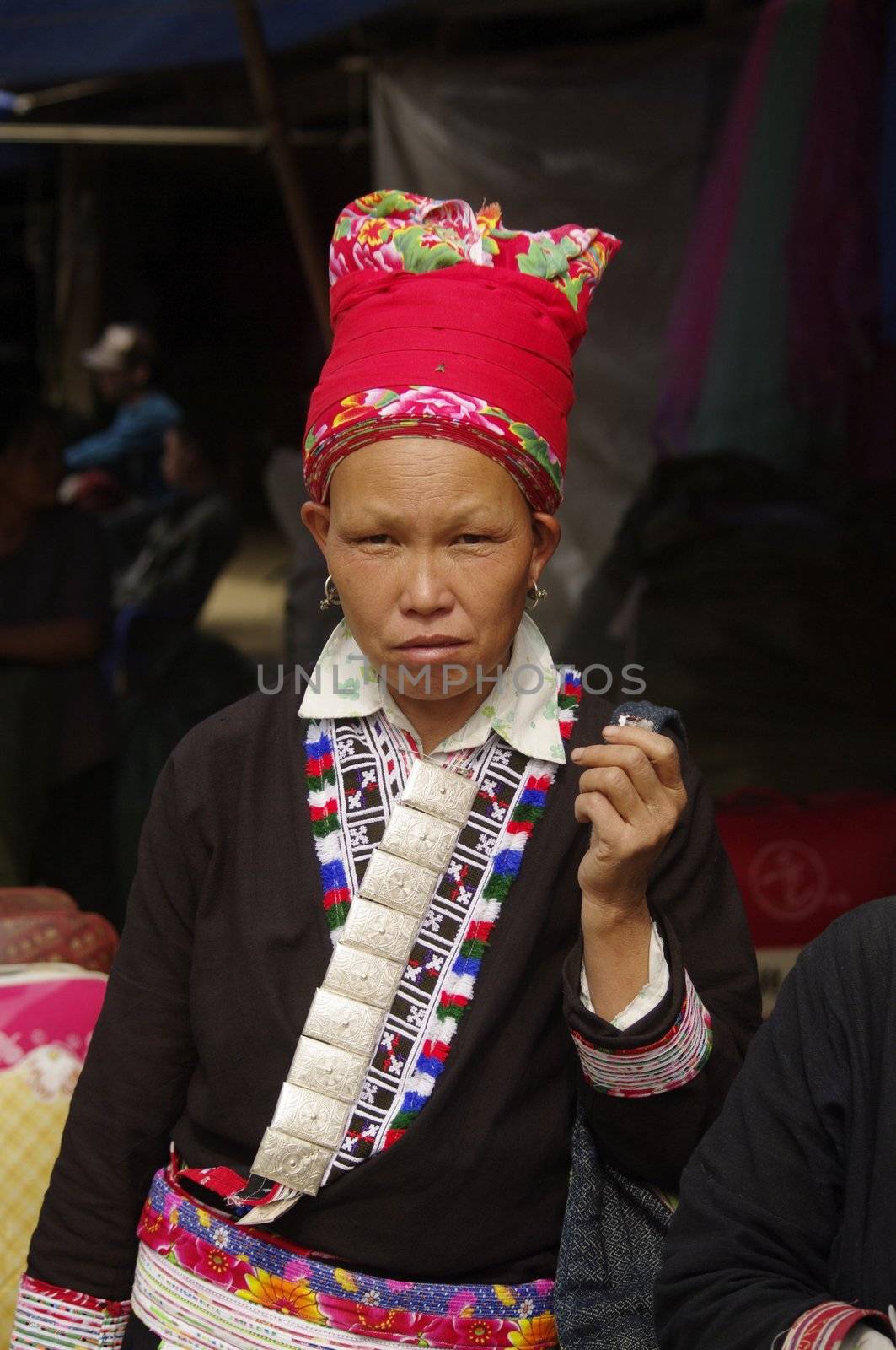 Portrait of a Woman Red Dao ethnic group in Muong Hum market, northern Vietnam near the Chinese border
