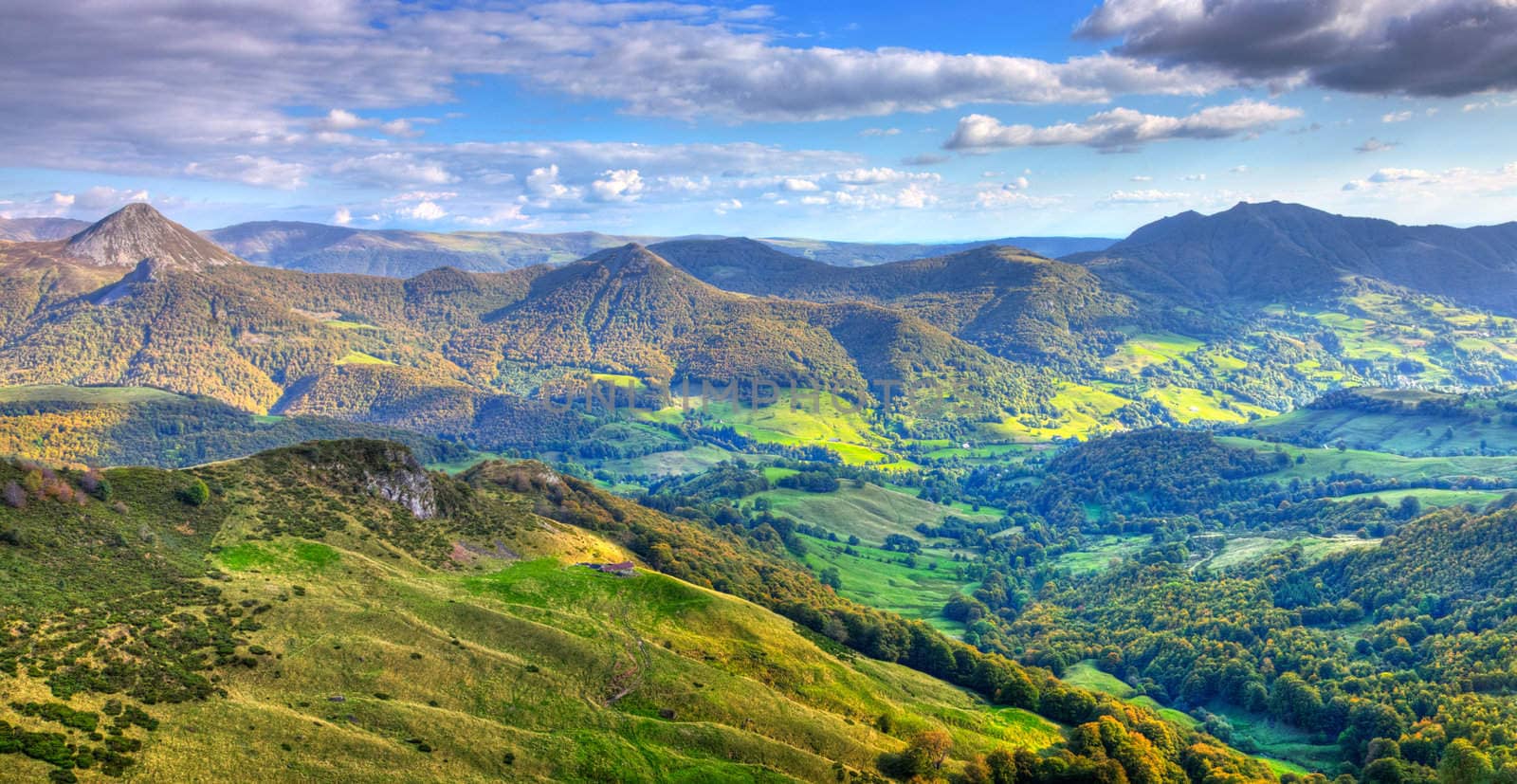 Beautiful panorama of the peaks, plateaus and valleys in Auvergne (Cantal) in The Central Massif located in south-central France.This region contains the largest concentration of extinct volcanoes in the world.