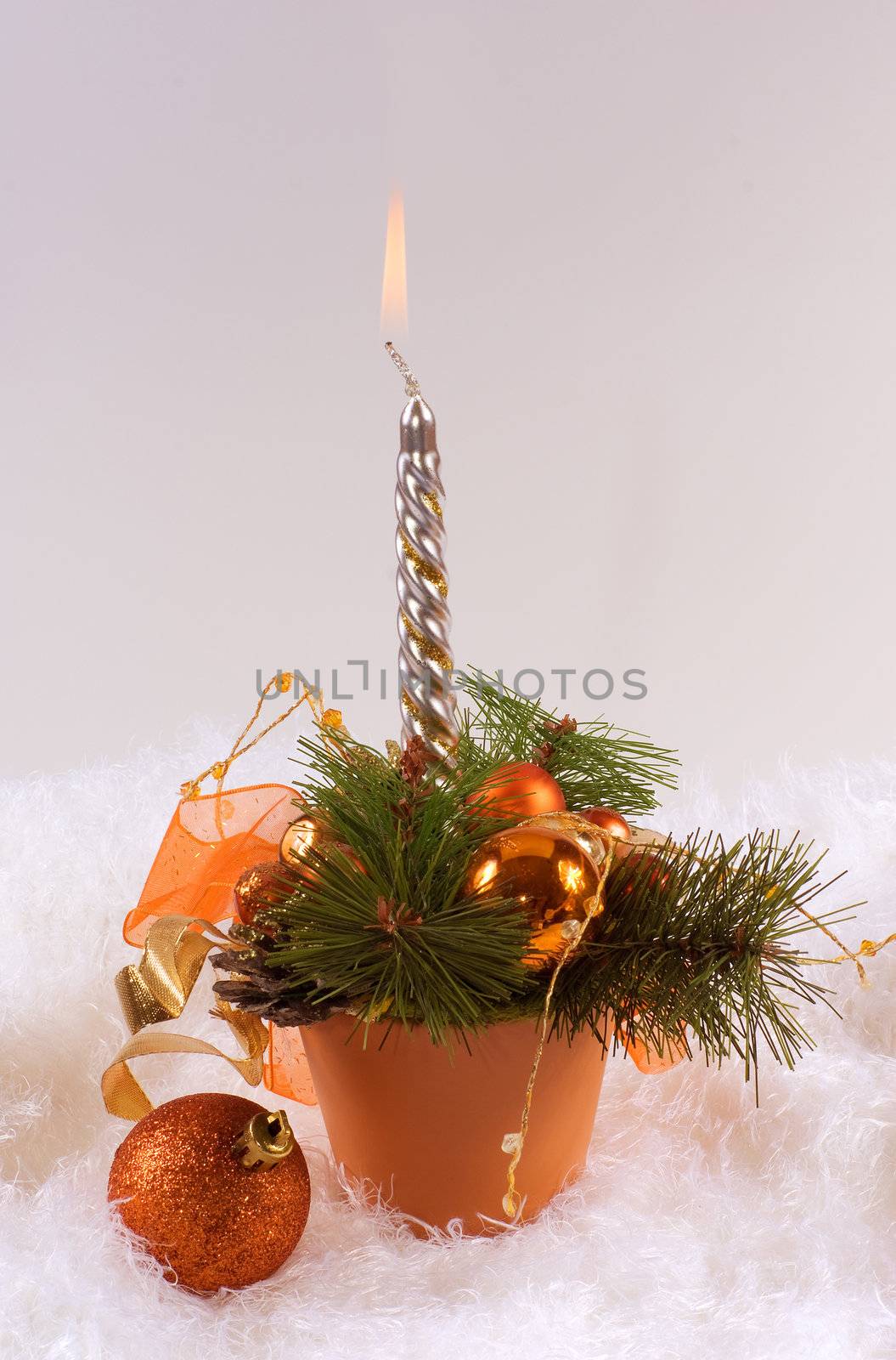 Christmas silver candles and red spheres on white skin