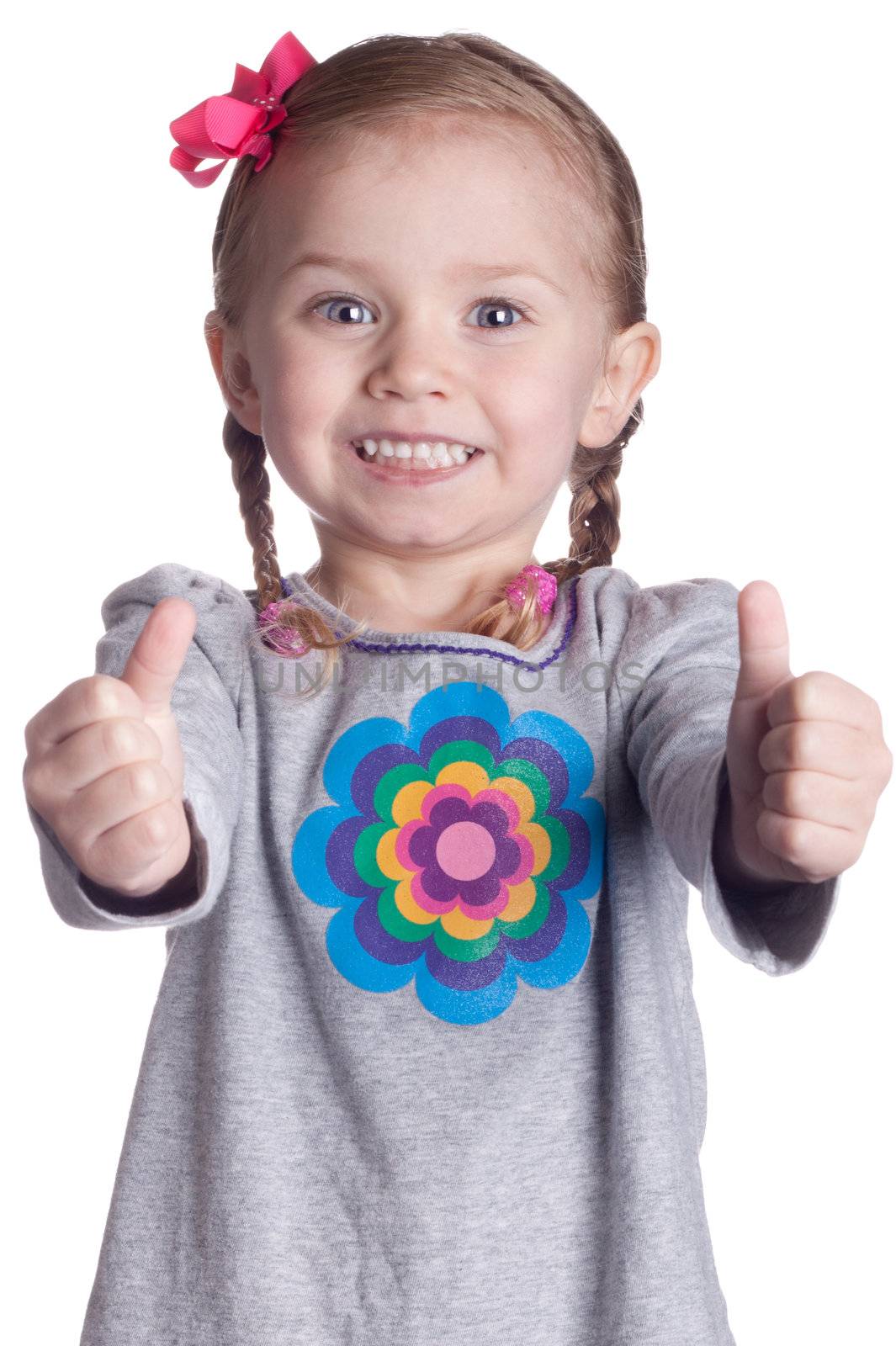 A cute young girl gives the viewer two thumbs up!  The thumbs are slightly out of focus which causes the viewers eye to be drawn to the excited look on the child's face.