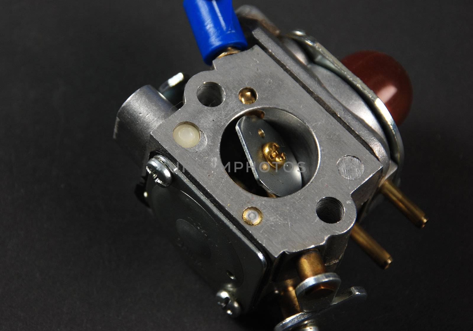 Stock pictures of a small gas engine and a carburetor