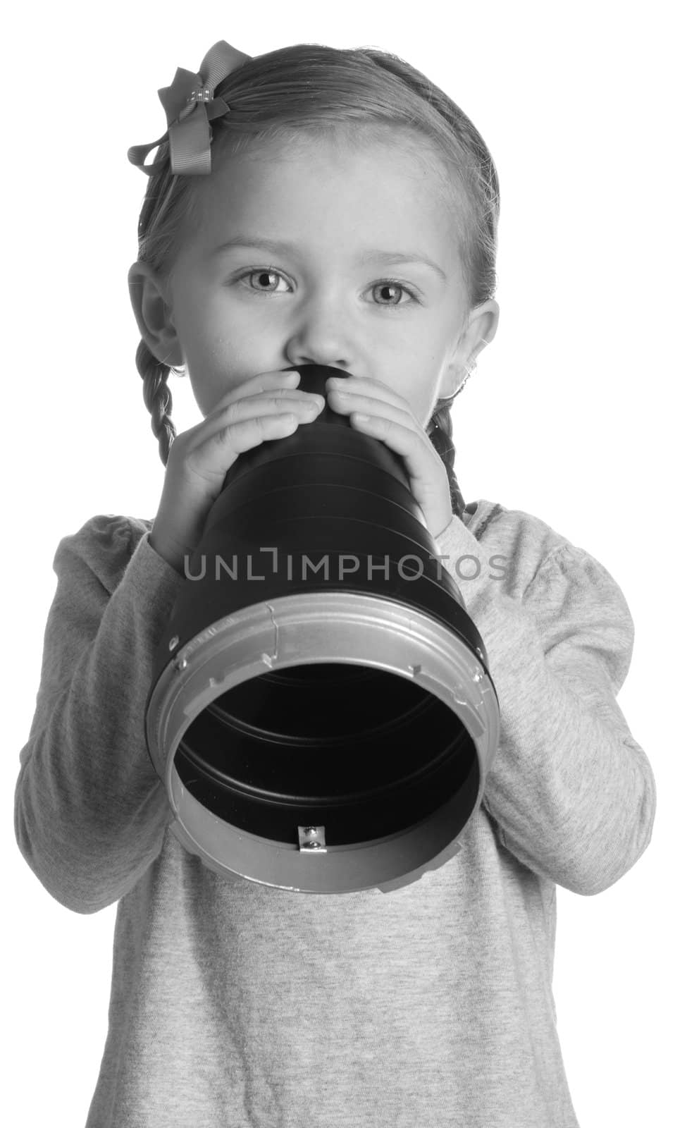 A very beautiful young child is announcing through a metal cone.  The photograph is done in black and white to lighten the mood of the photograph.