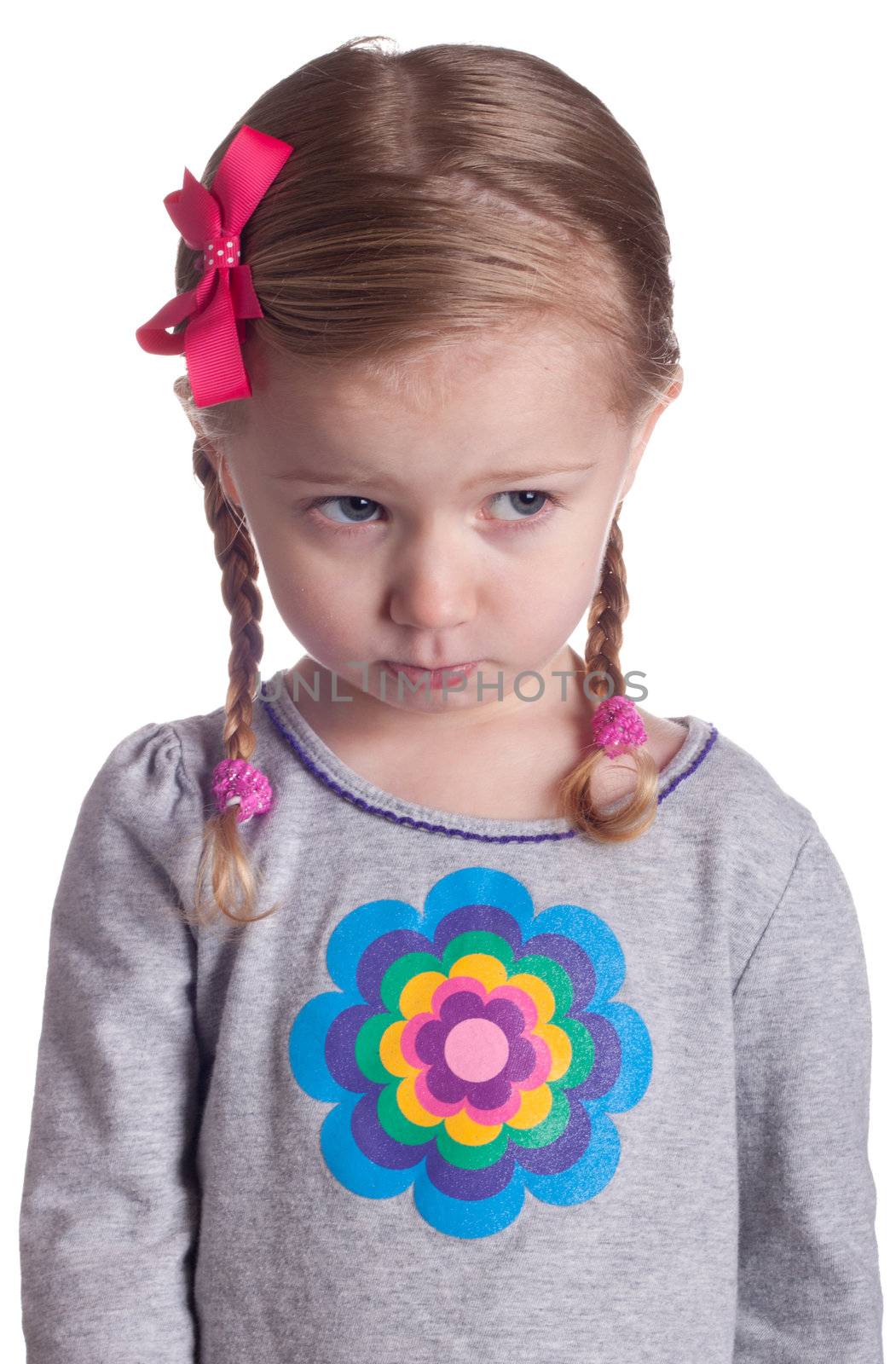 An innoncent young girl is pouting and giving someone the puppy dog eyes.