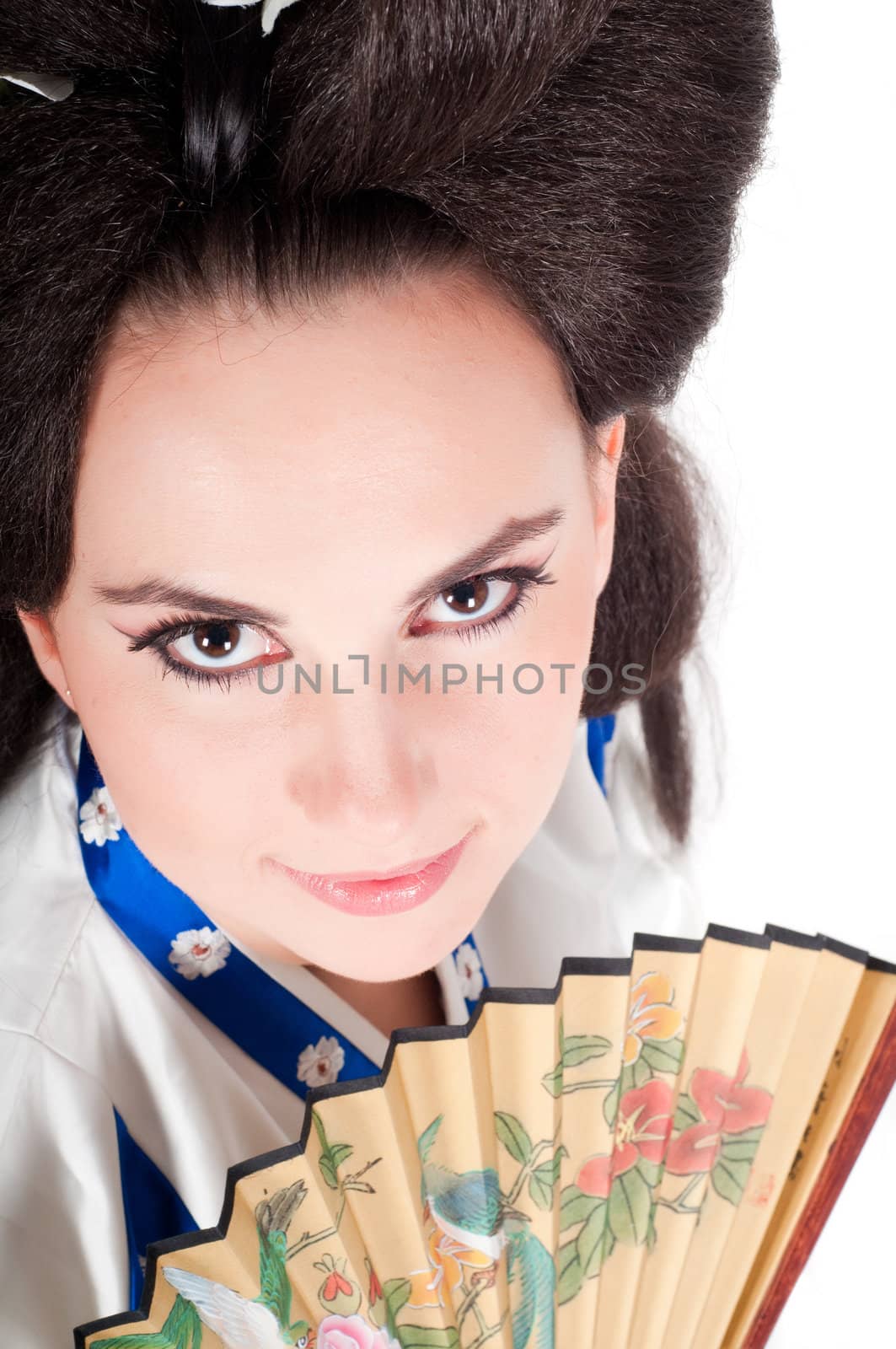 Portrait of the girl of the Asian appearance with a make-up under the geisha on a white background