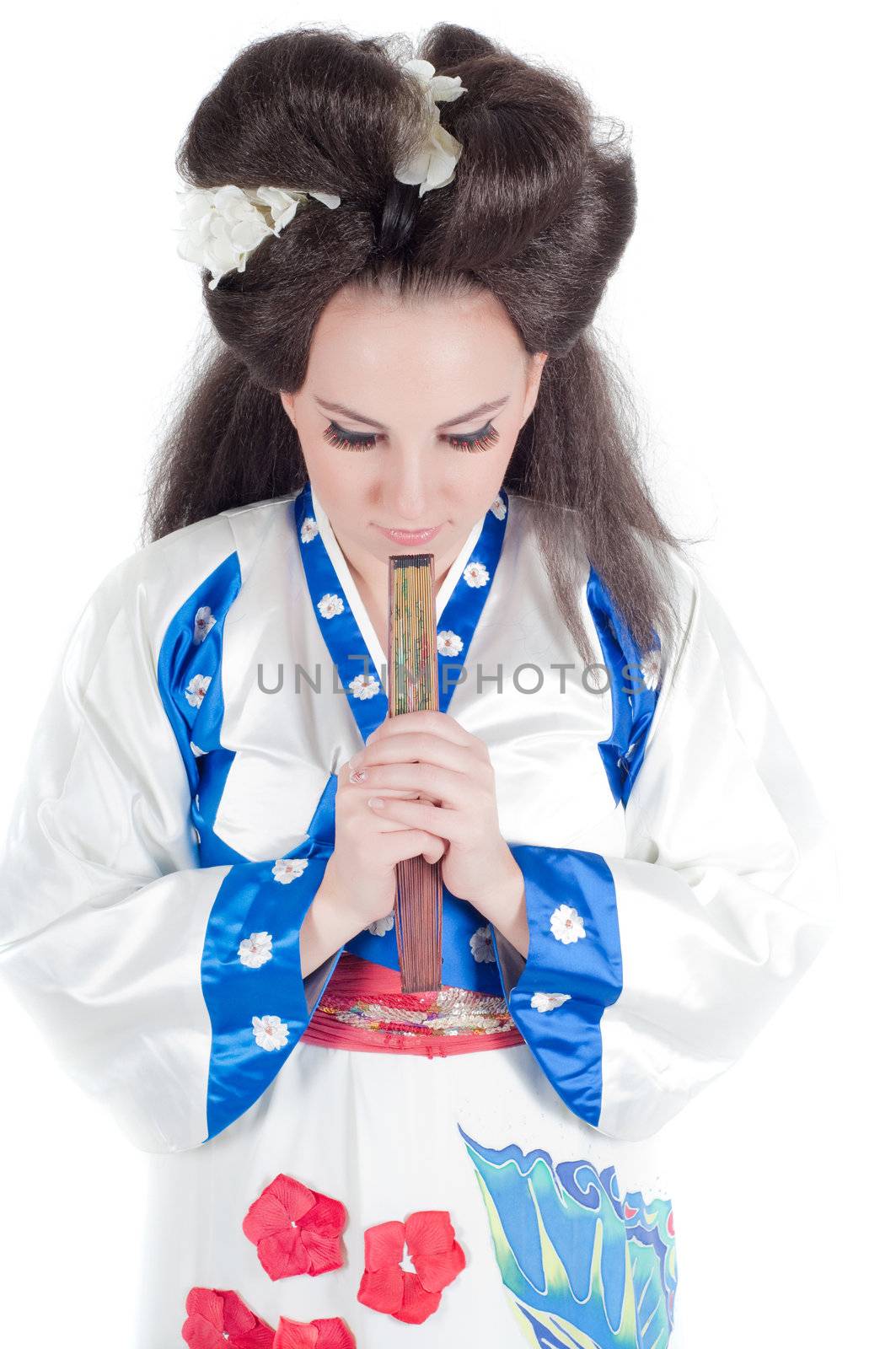 Portrait of the girl of the Asian appearance with a make-up under the geisha on a white background