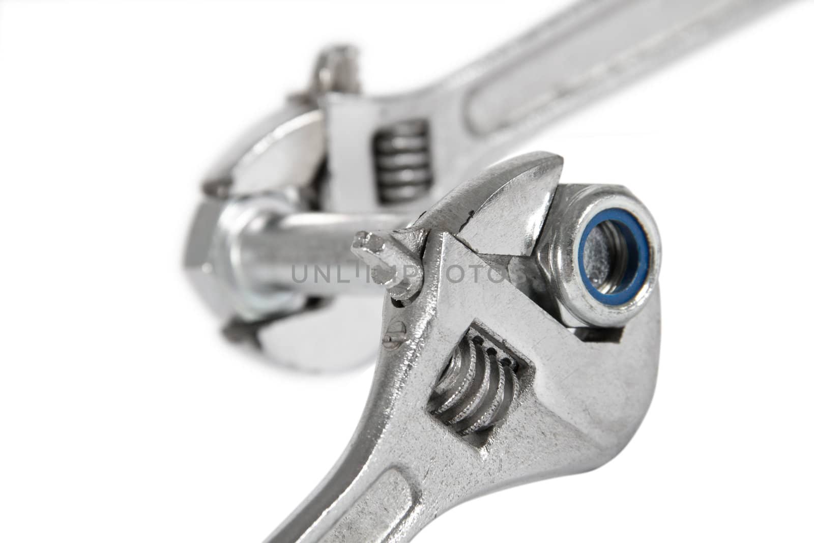 The image of the wrench which is turning off a nut from a bolt, isolated, on a white background