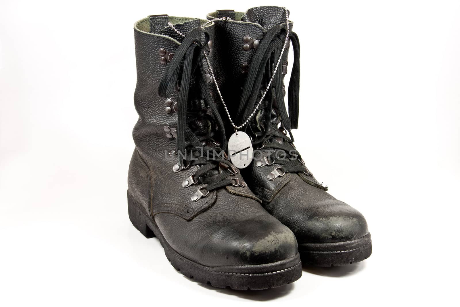 Picture of some old army boots with a dog-tag hanging