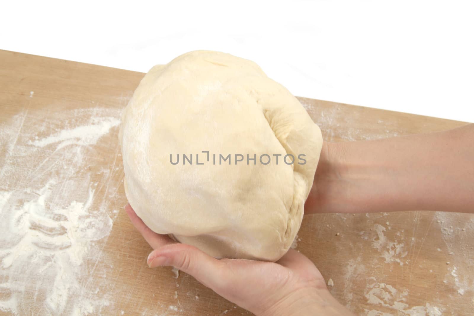 Beautiful women's hands knead the dough for baking