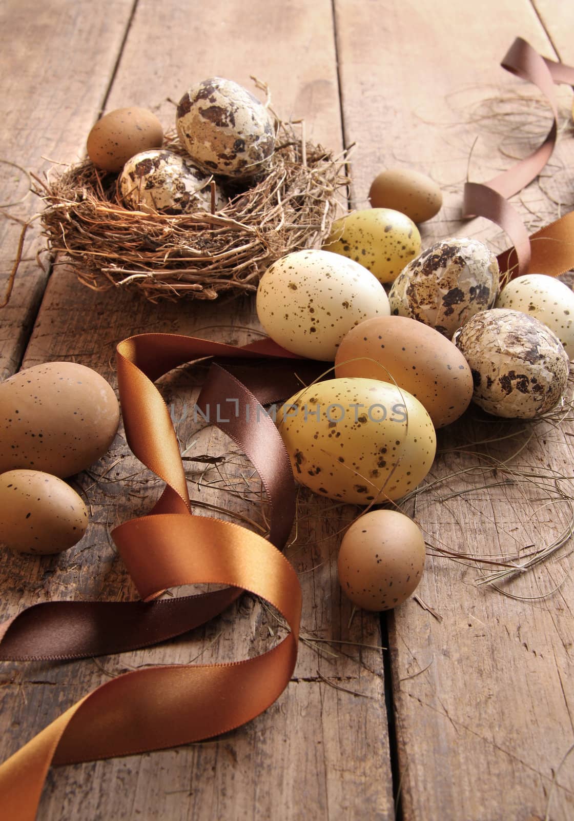 Brown and yellow speckled eggs with ribbons for easter