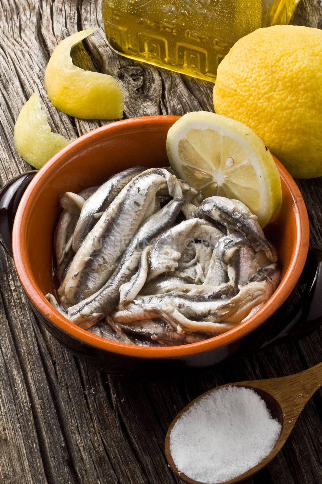 anchovies with olive oil and lemon on a bowl