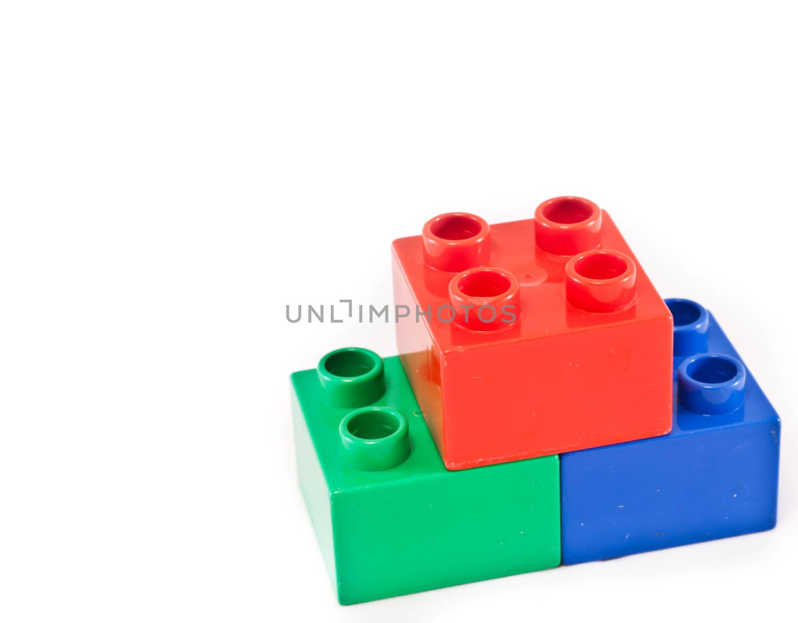 Plastic building blocks on white background. Bright colors.
